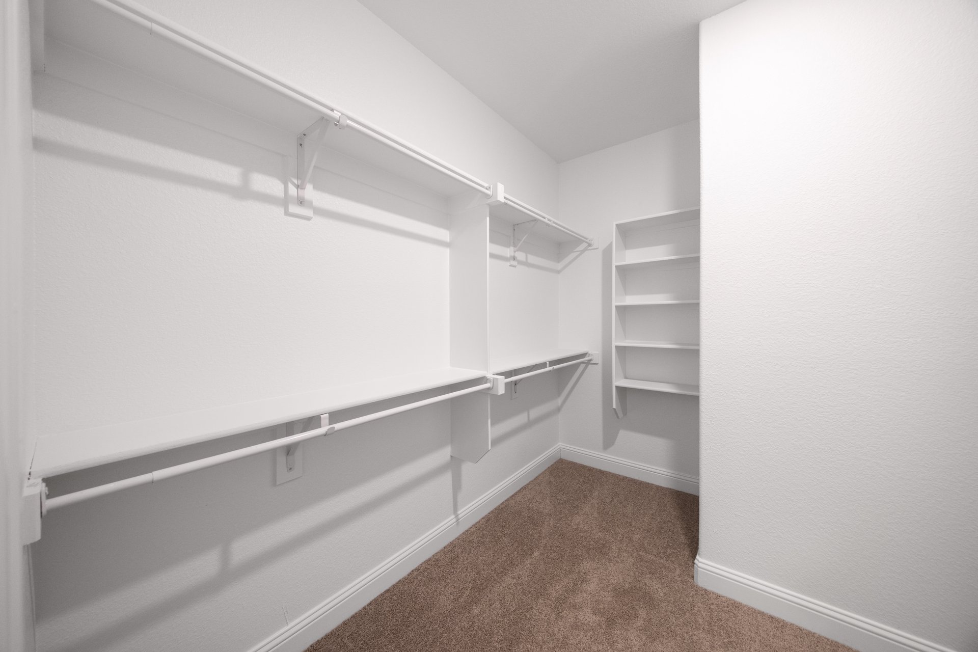 closet with hanging racks and shelves 