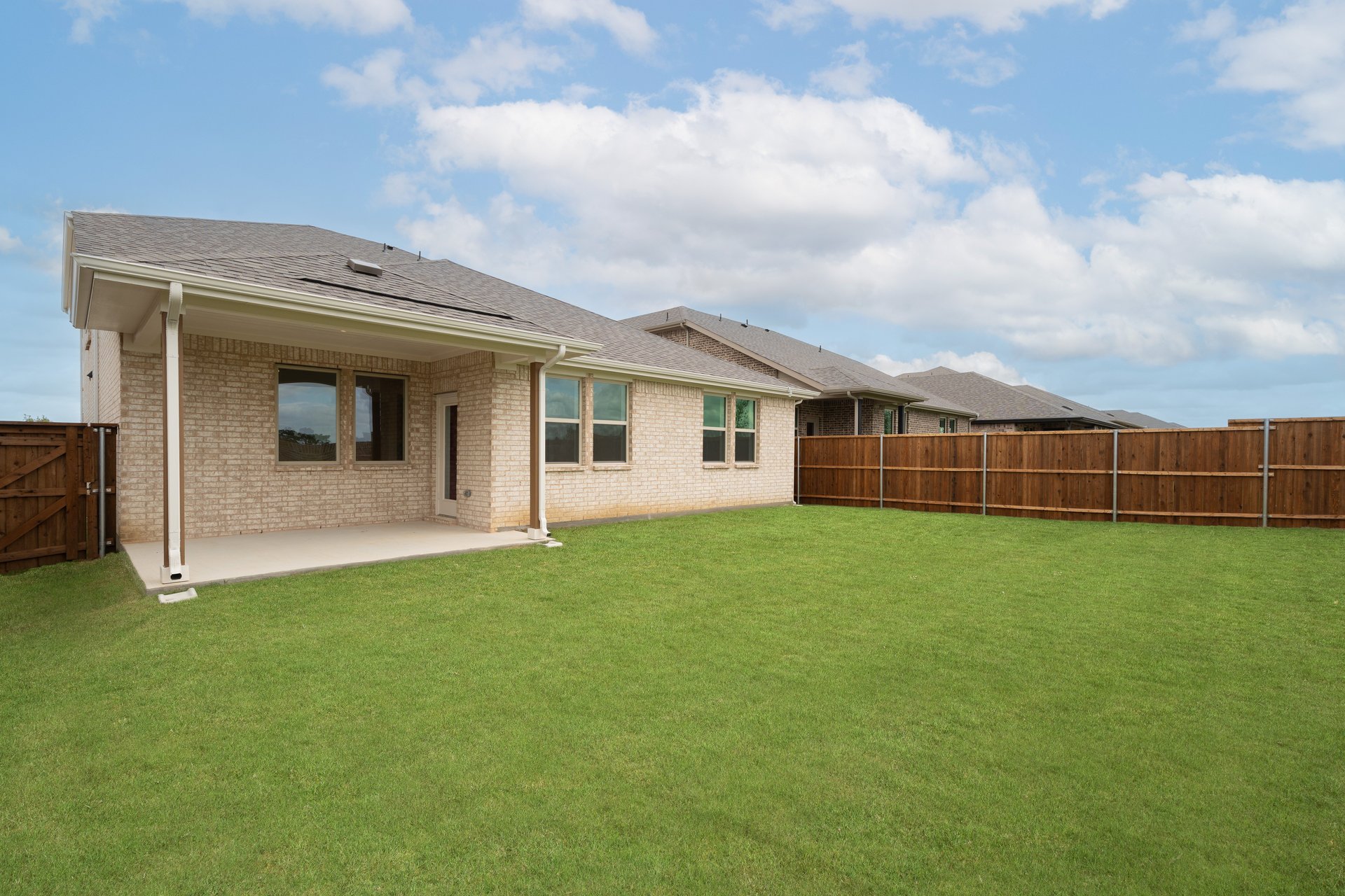 backyard with grass and covered patio