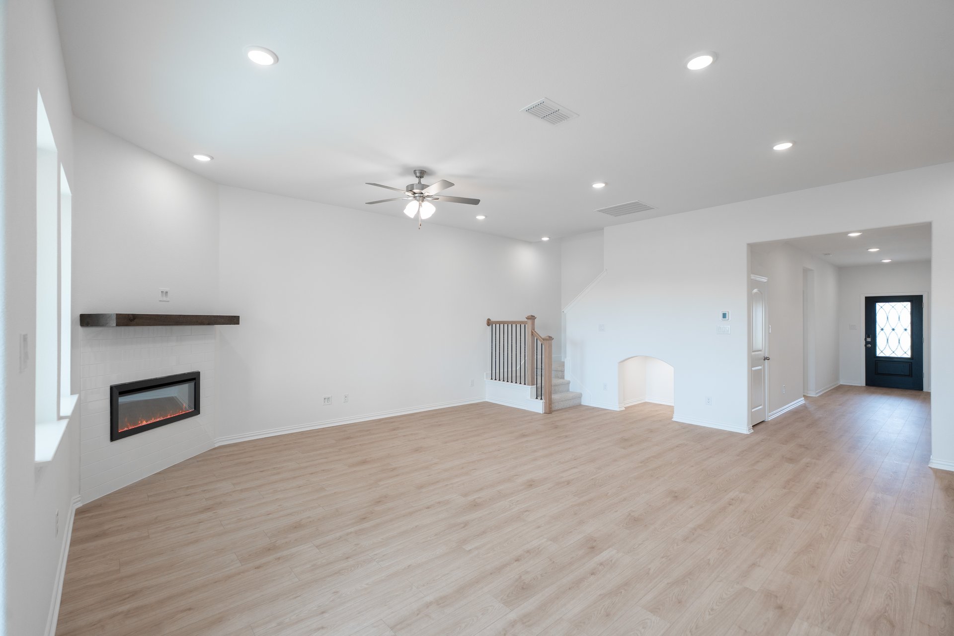open great room with wood floors and fireplace