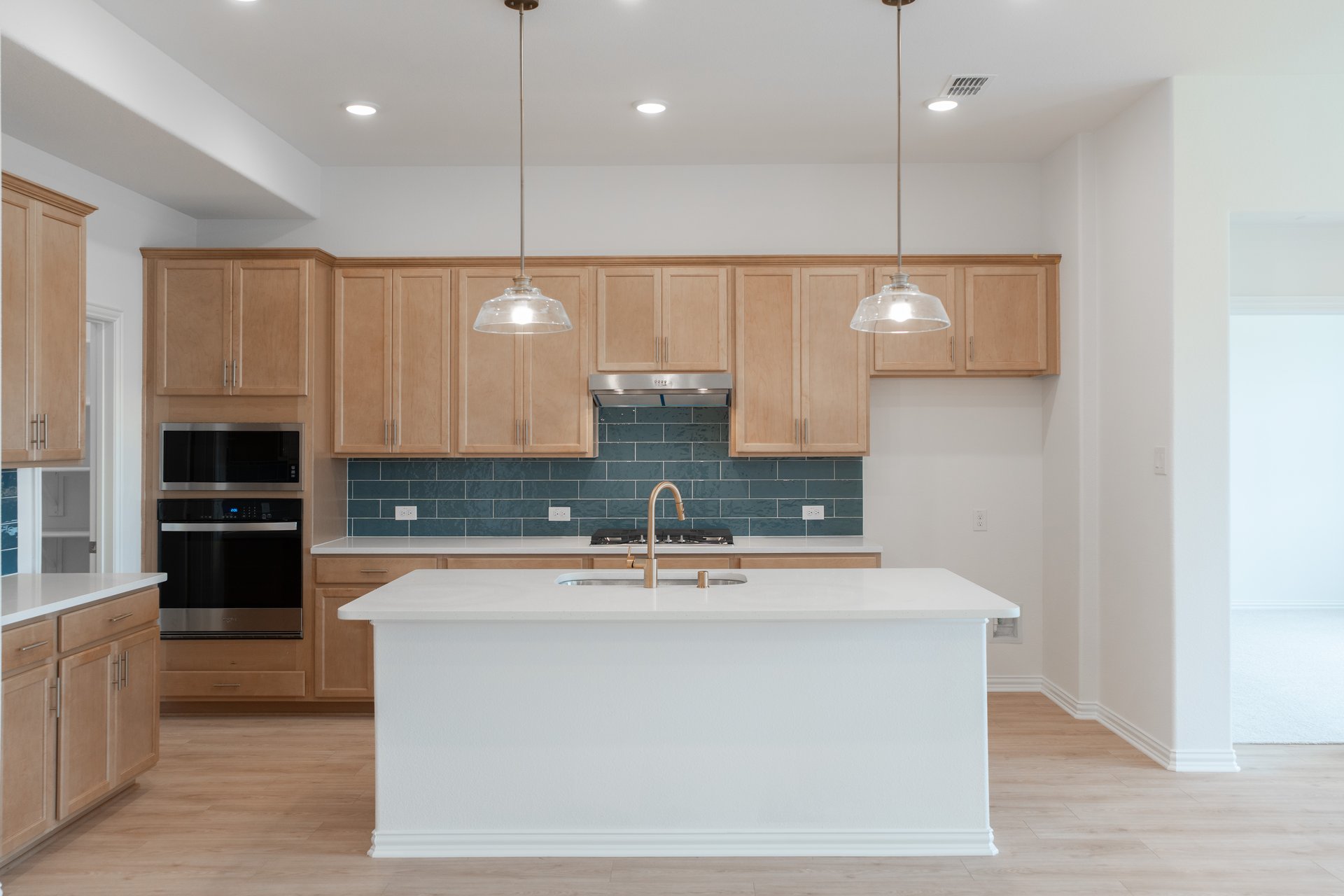 open kitchen with wood floors and island