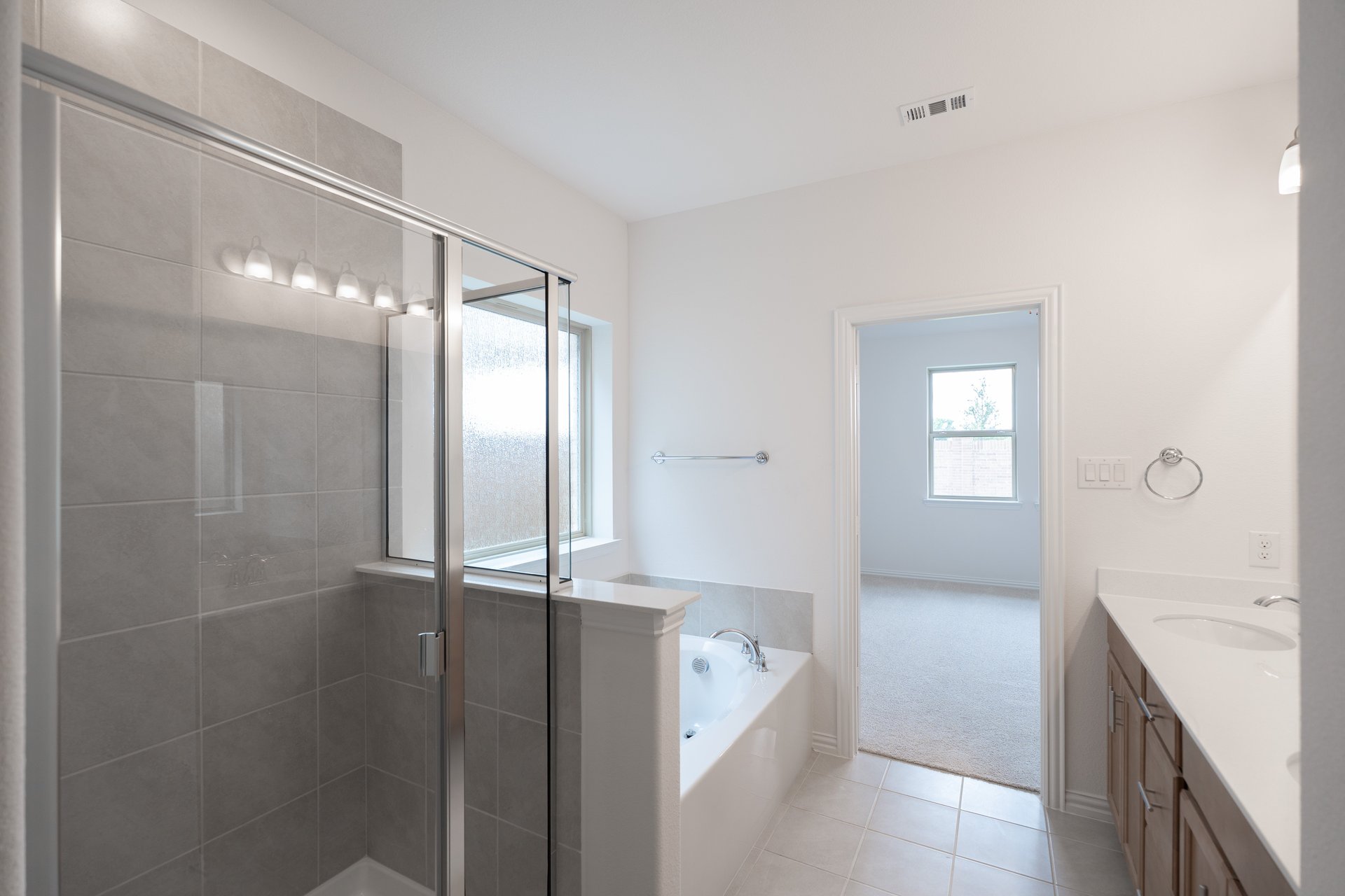 primary bathroom with soaking tub and walk-in shower
