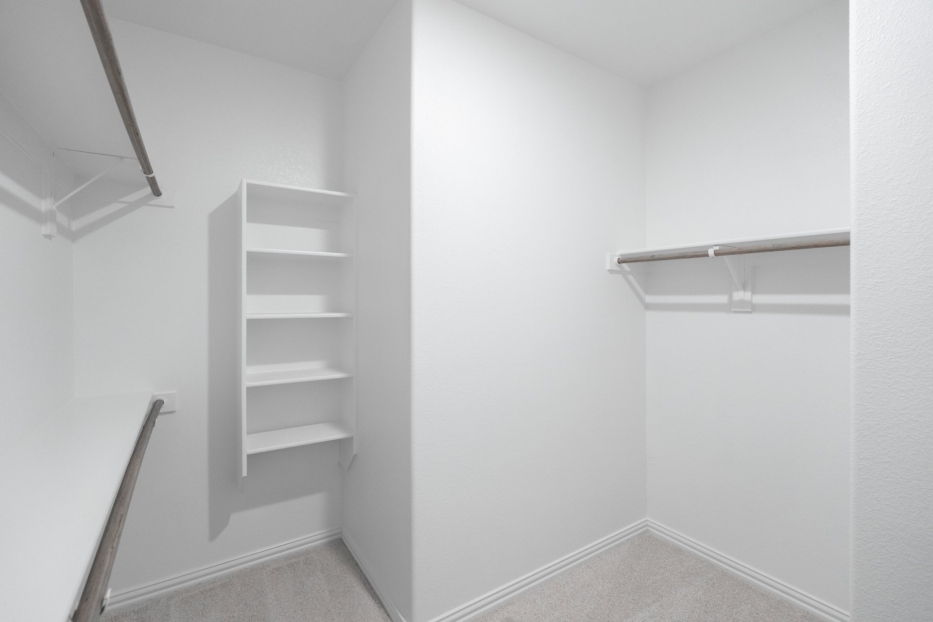 primary bedroom closet with carpet and white shelves