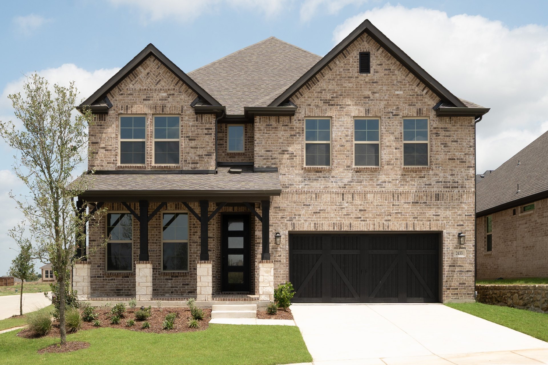 two-story home with brick and stone exterior