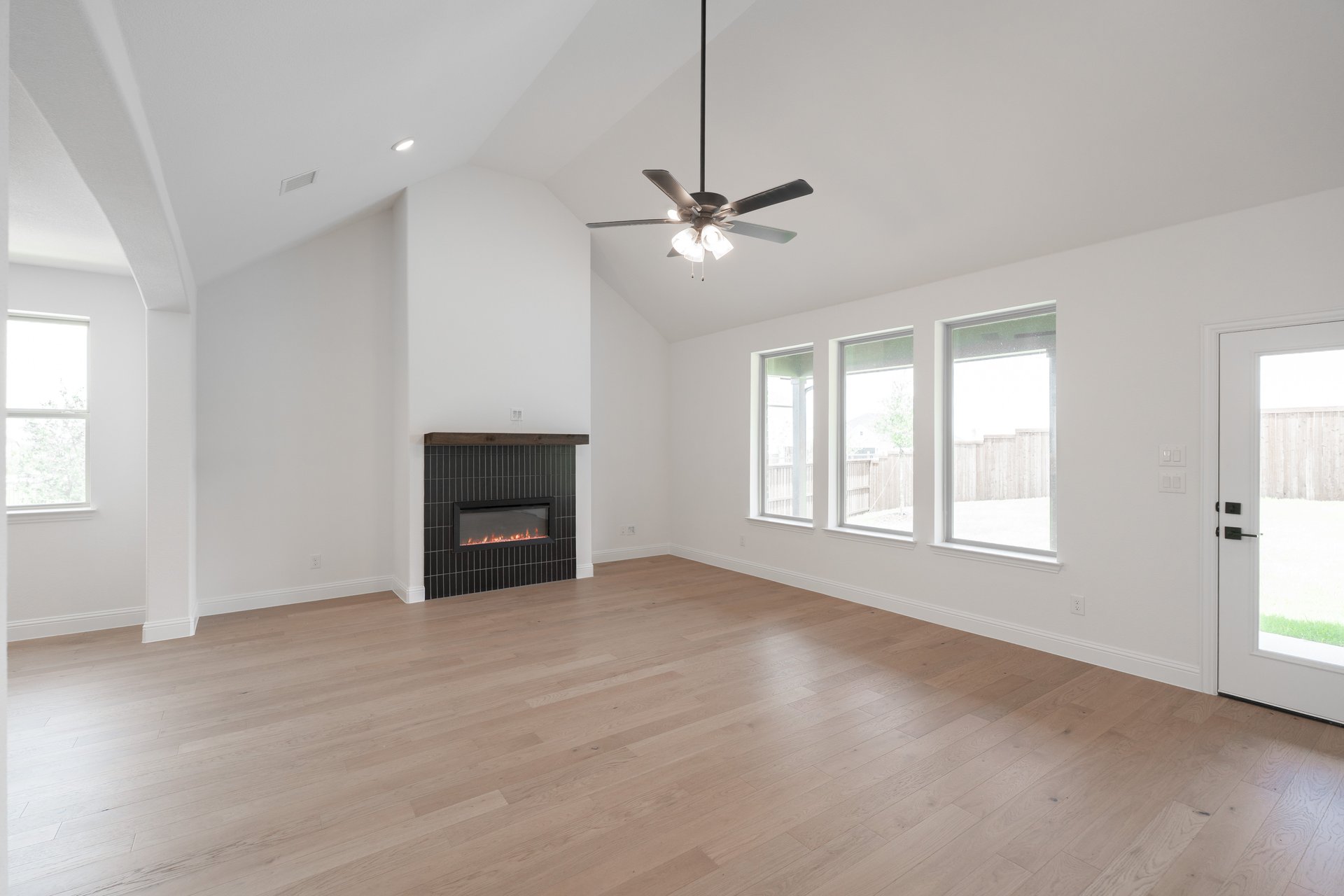 open great room with wood floors and fireplace