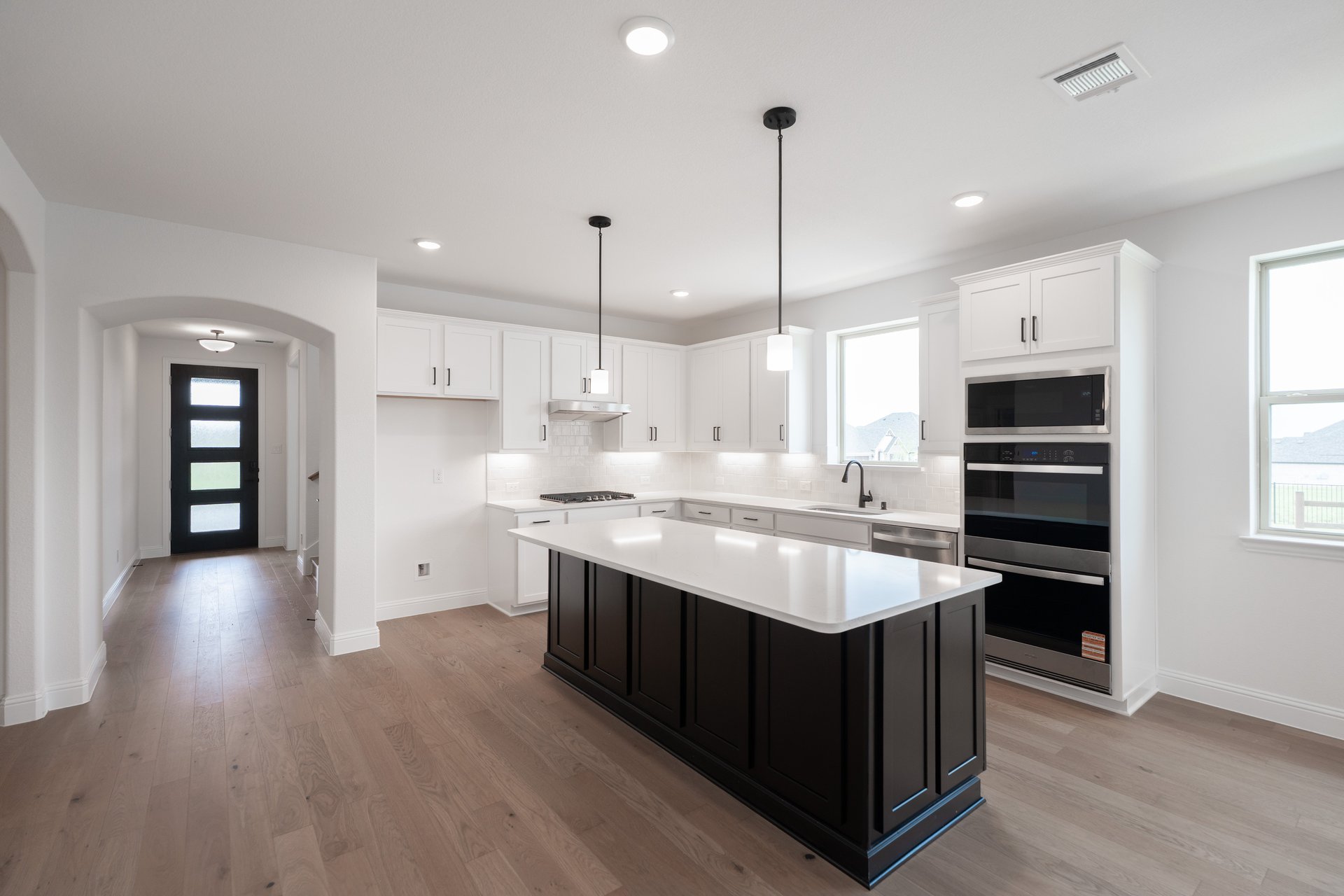 open kitchen with wood floors and island