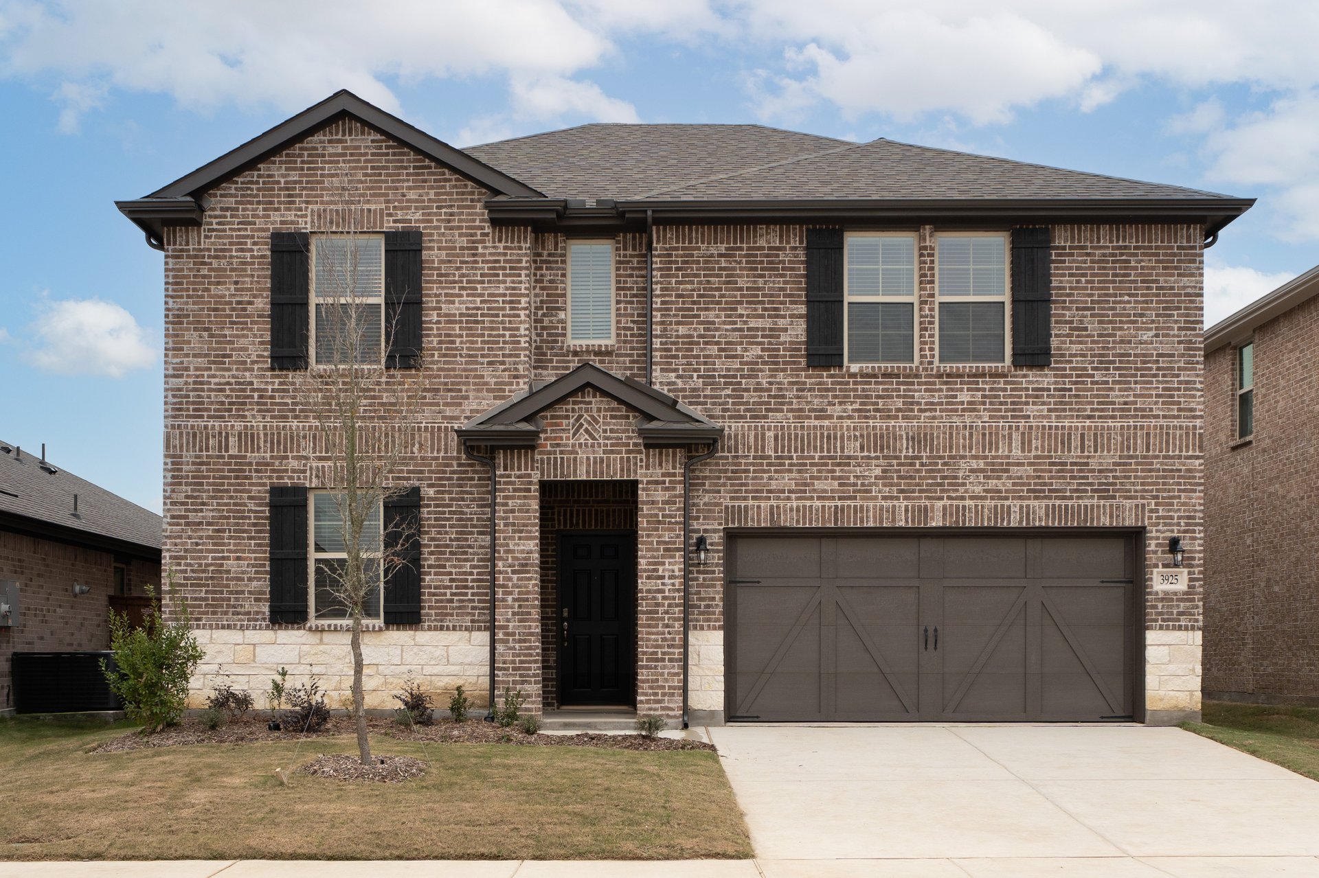 two-story home with brick and stone exterior