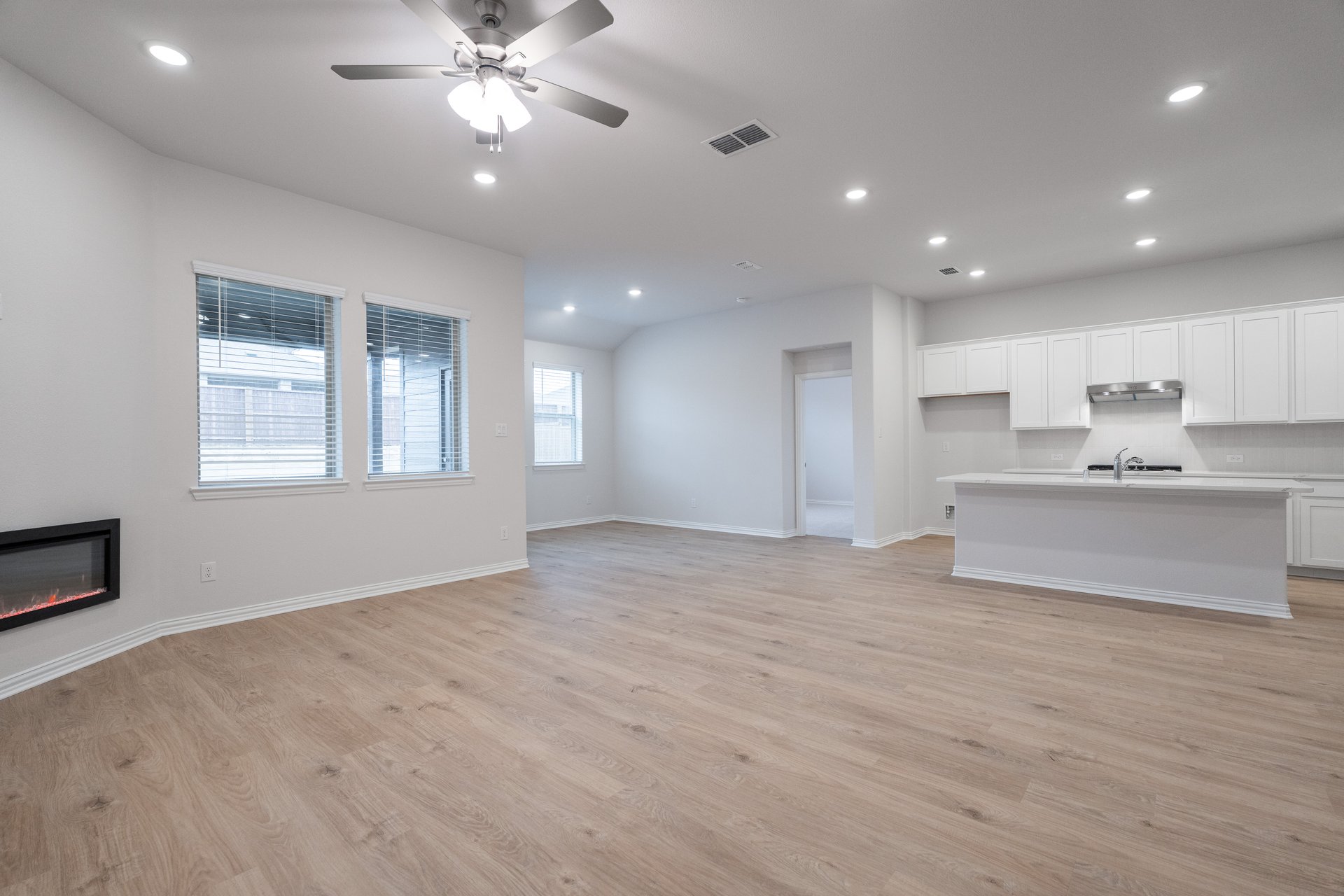 open great room with wood floors and fireplace
