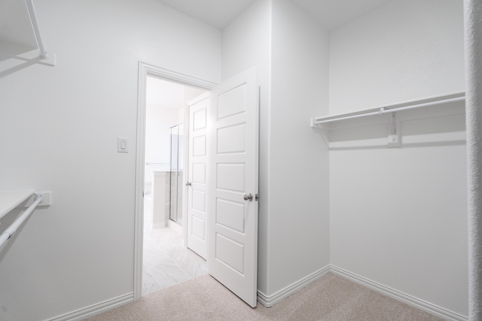 primary bedroom closet with carpet and white shelves