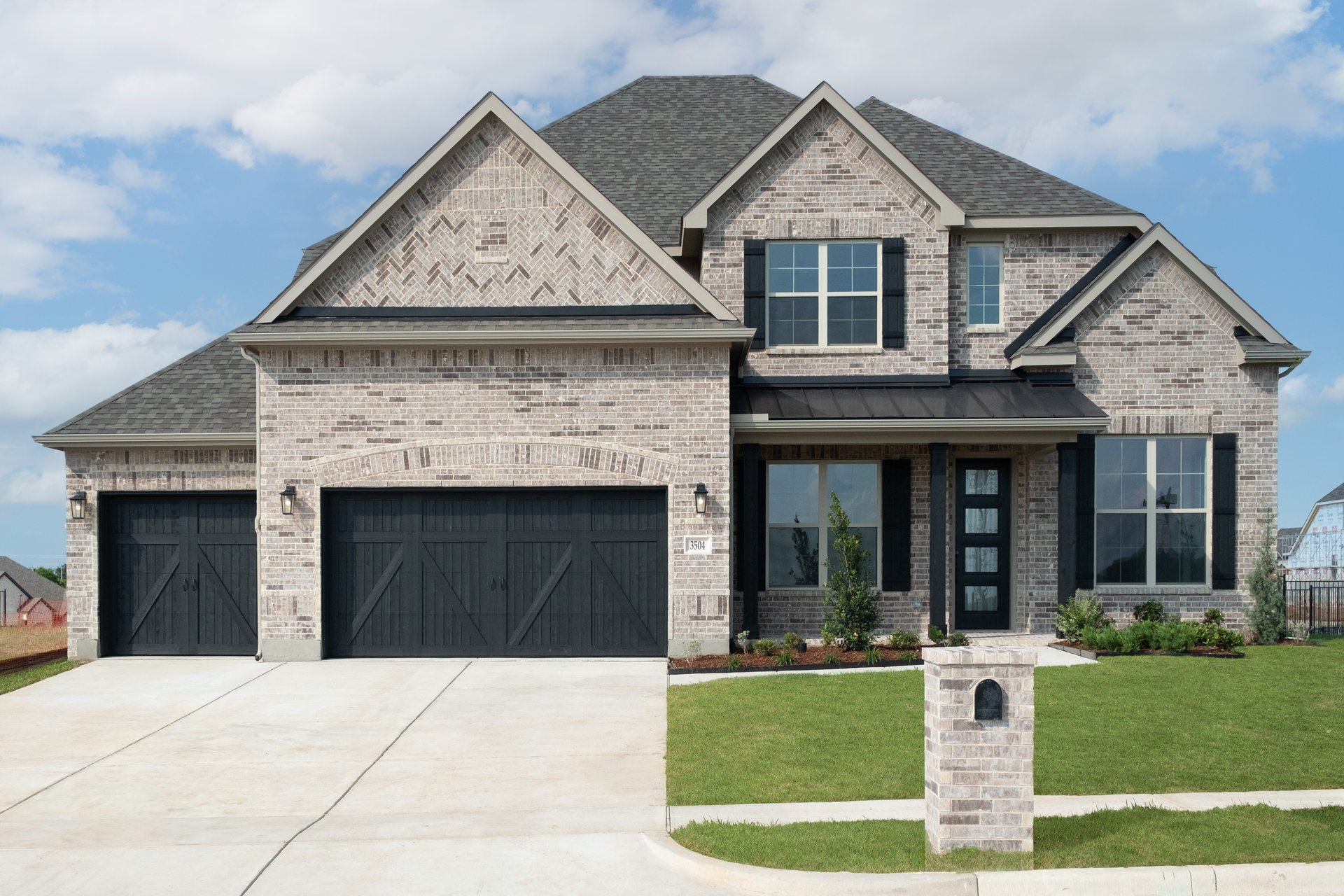 two-story home with brick and shutters