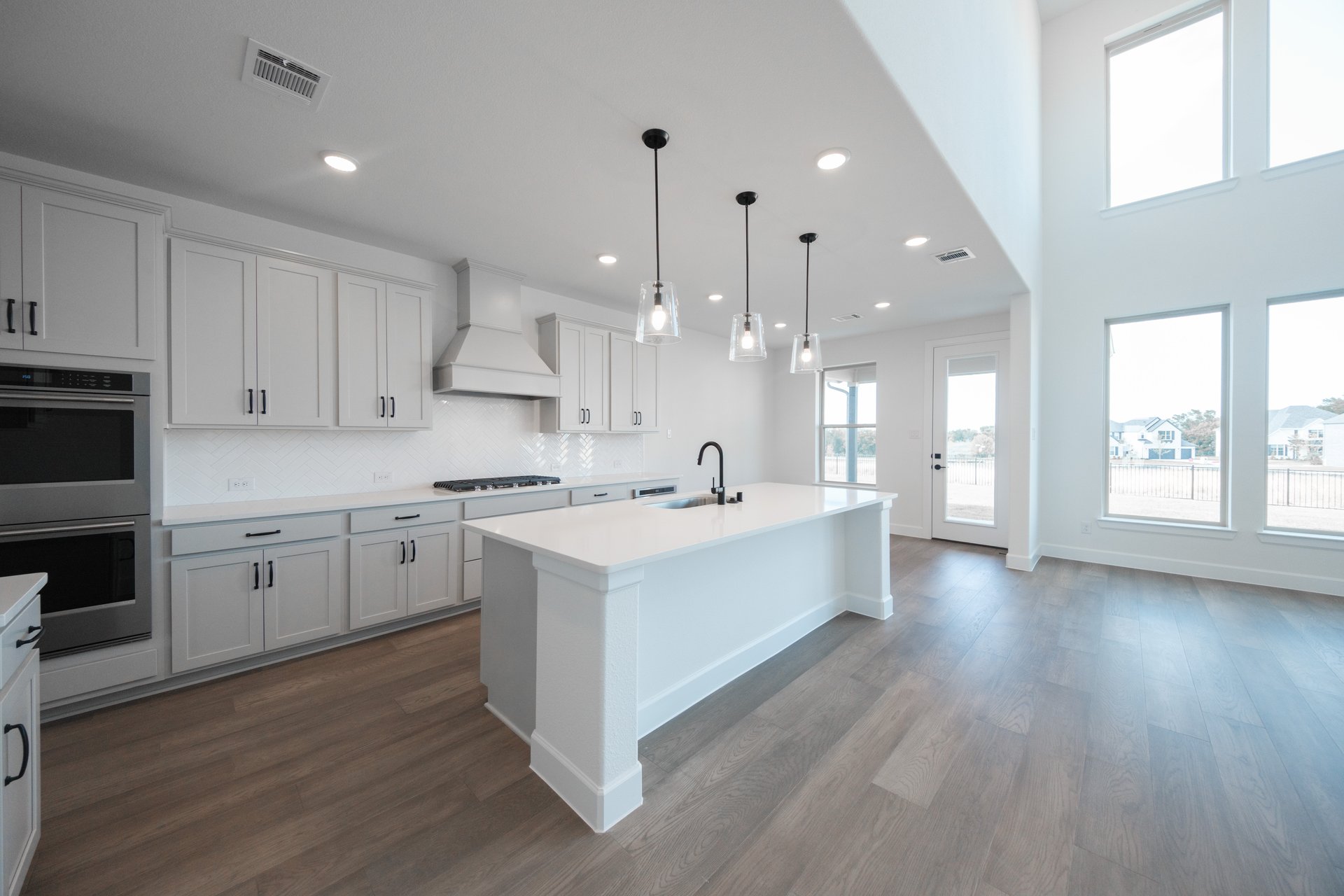 open kitchen with wood floors and island