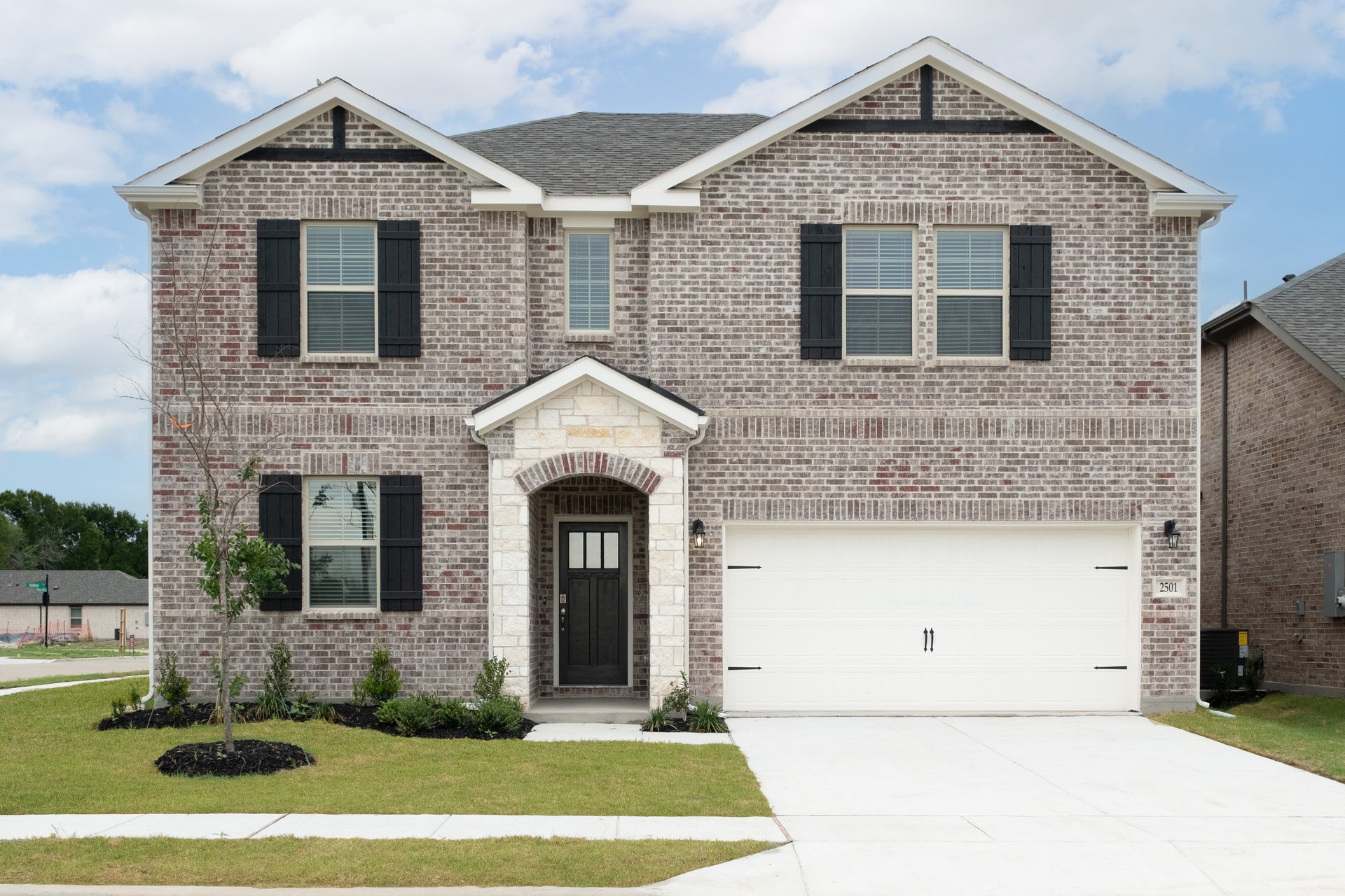 two-story home with brick and stone exterior