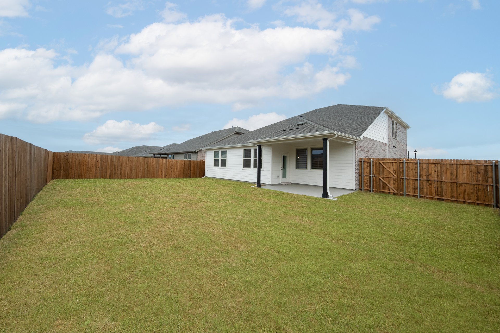backyard with grass and covered patio