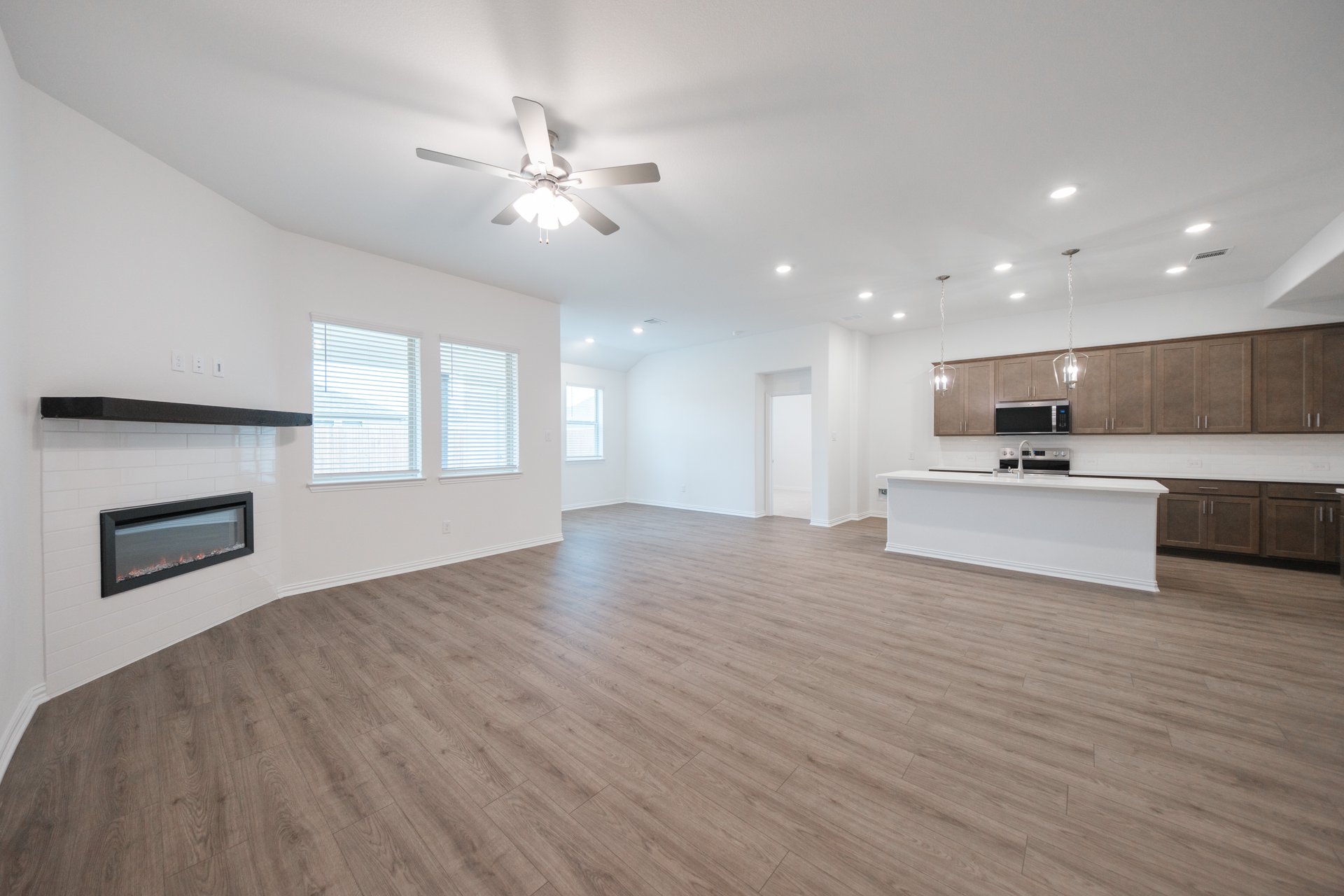 open great room with wood floors and fireplace