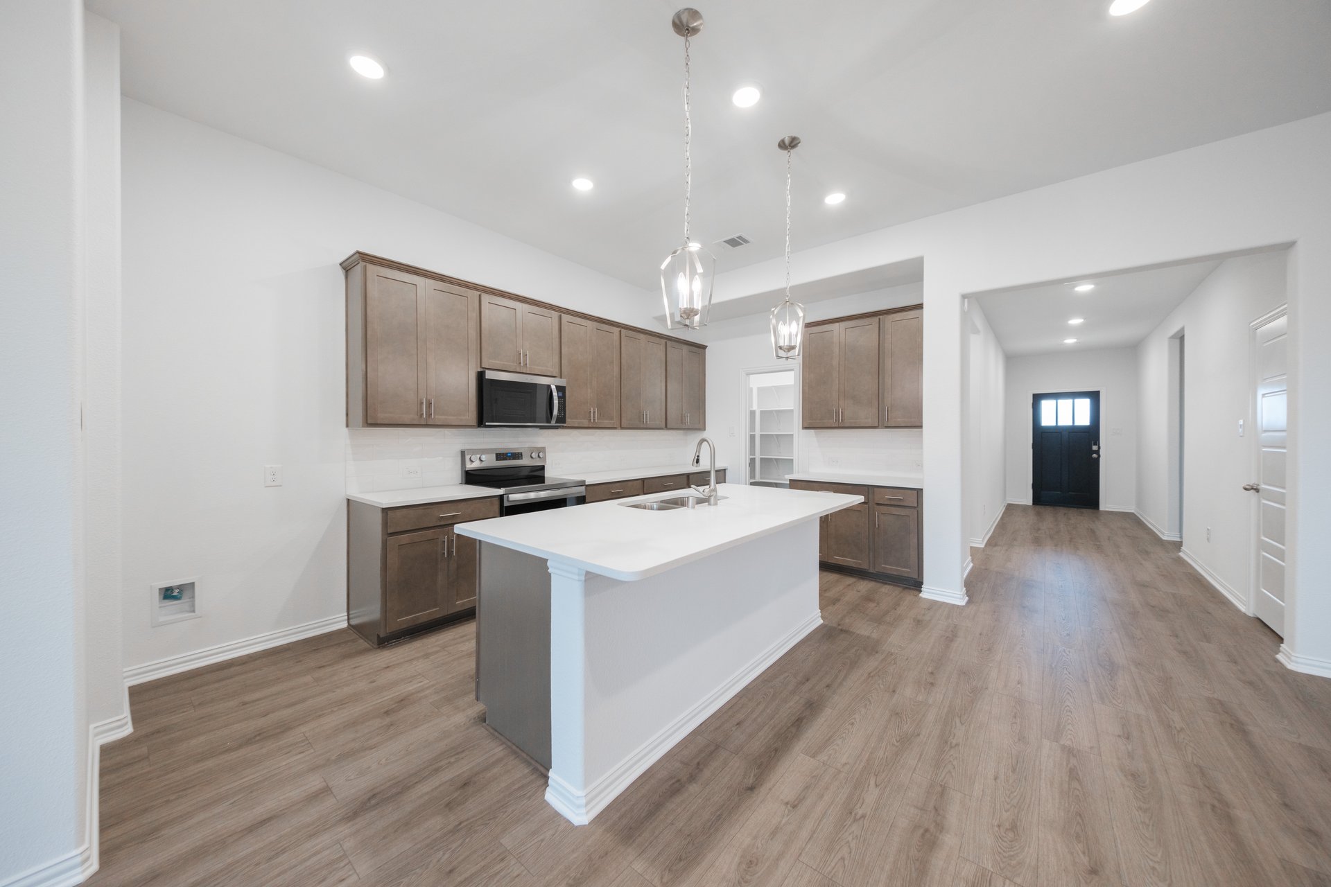 open kitchen with wood floors and island