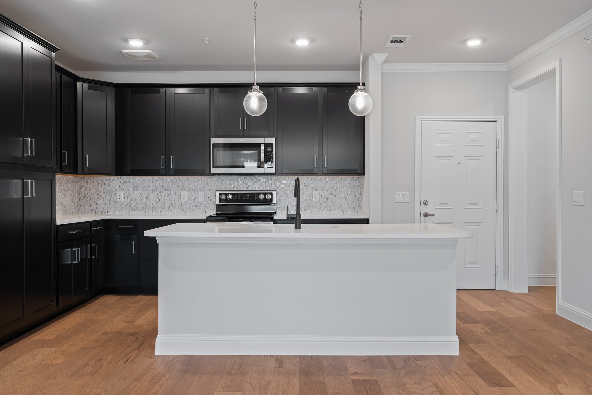 spacious kitchen with black cabinets