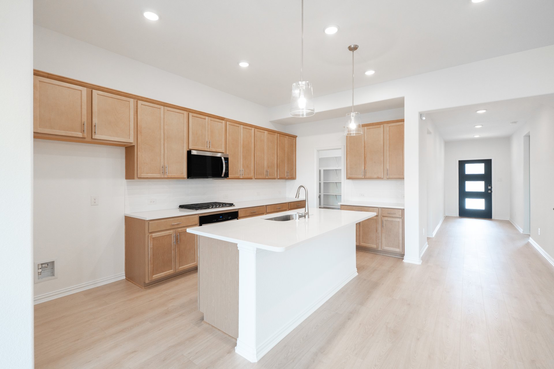open kitchen with brown cabinets and hardwood flooring