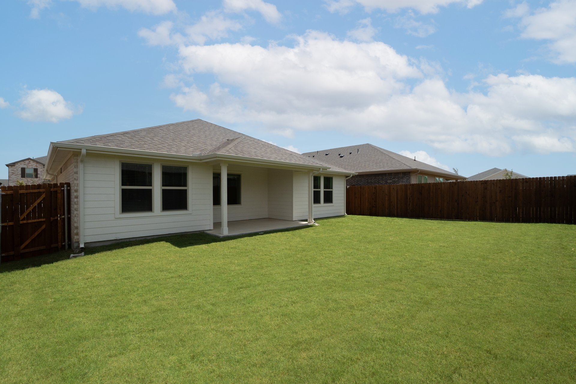backyard with grass and covered patio