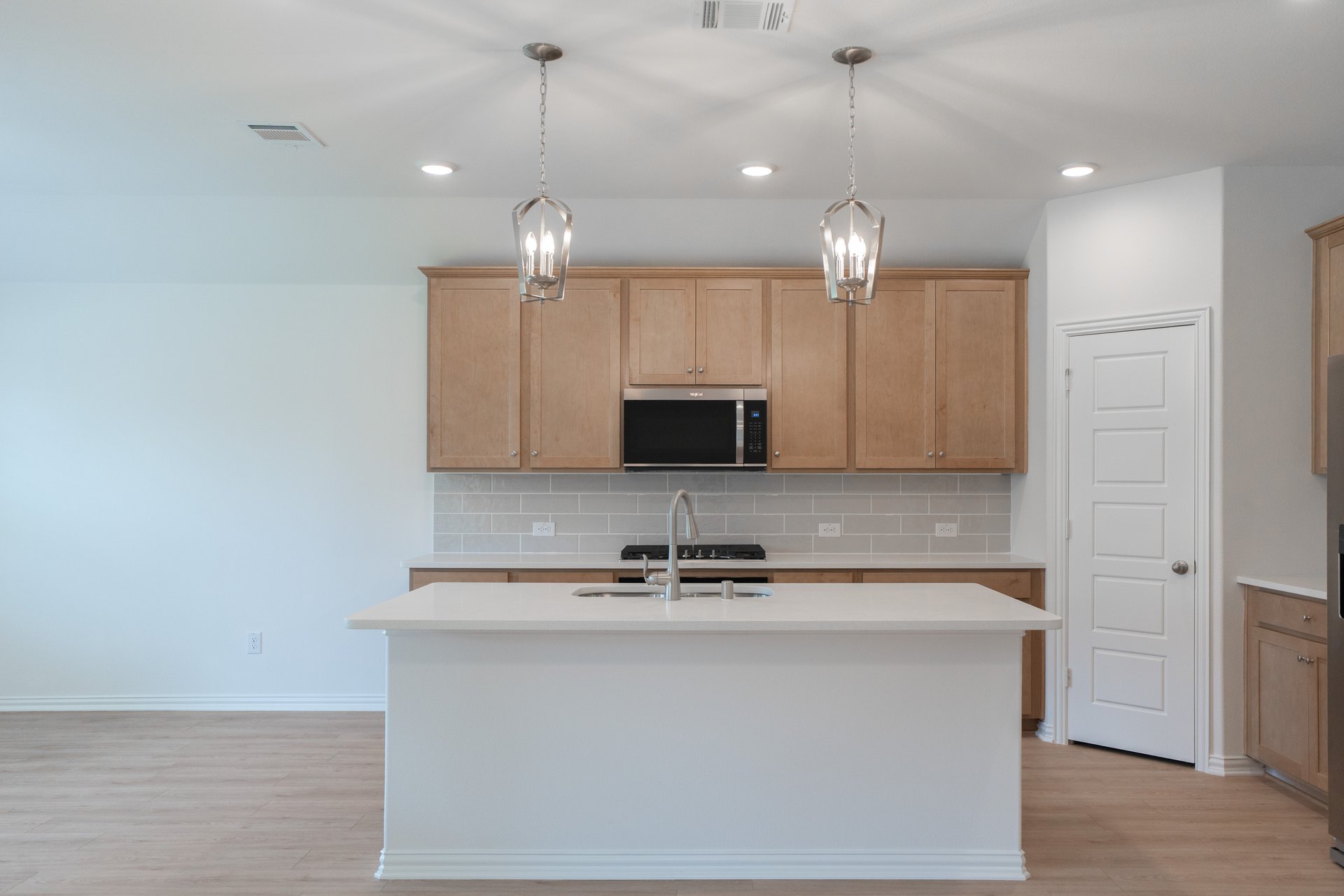 open kitchen with wood floors and island