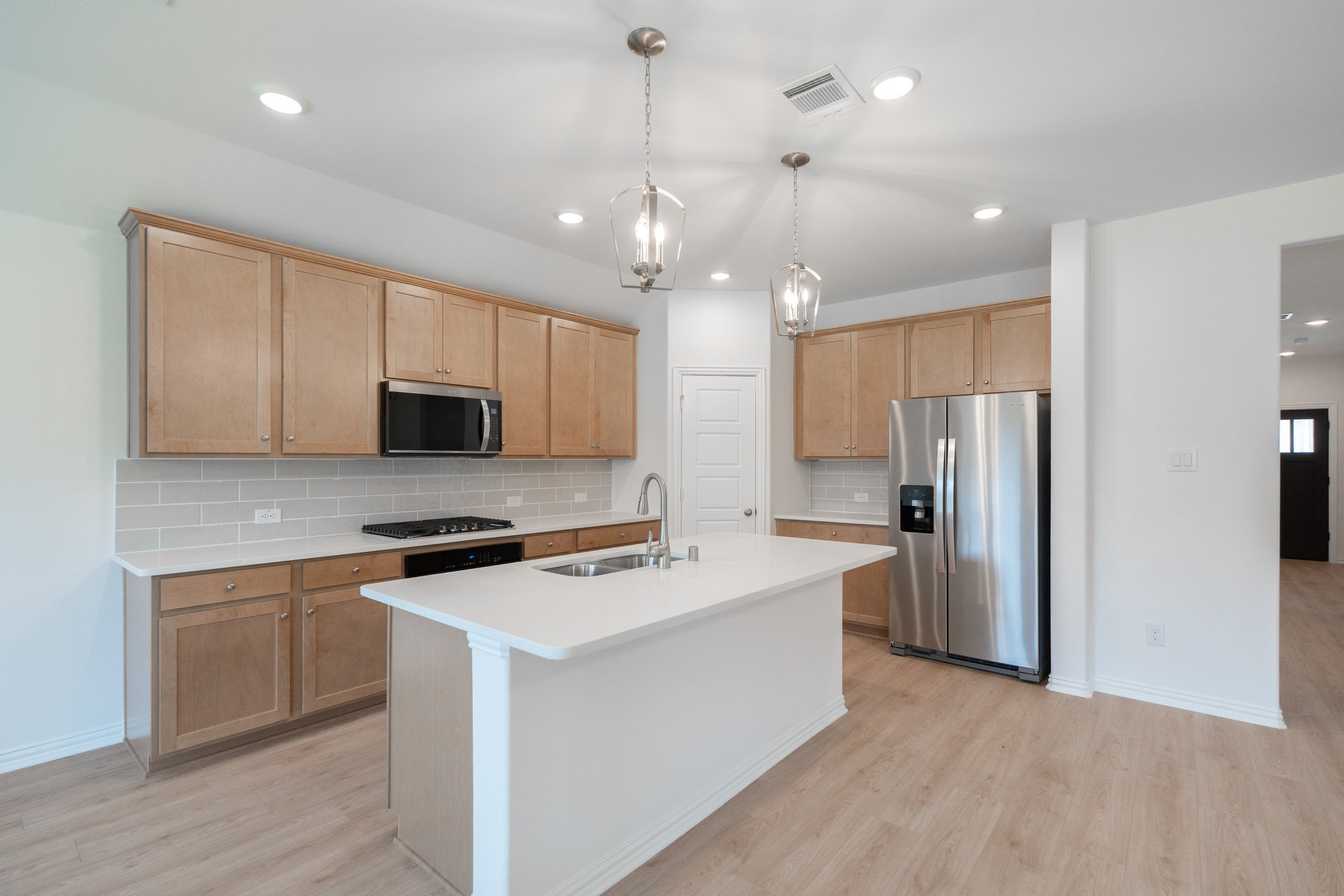 open kitchen with wood floors and island