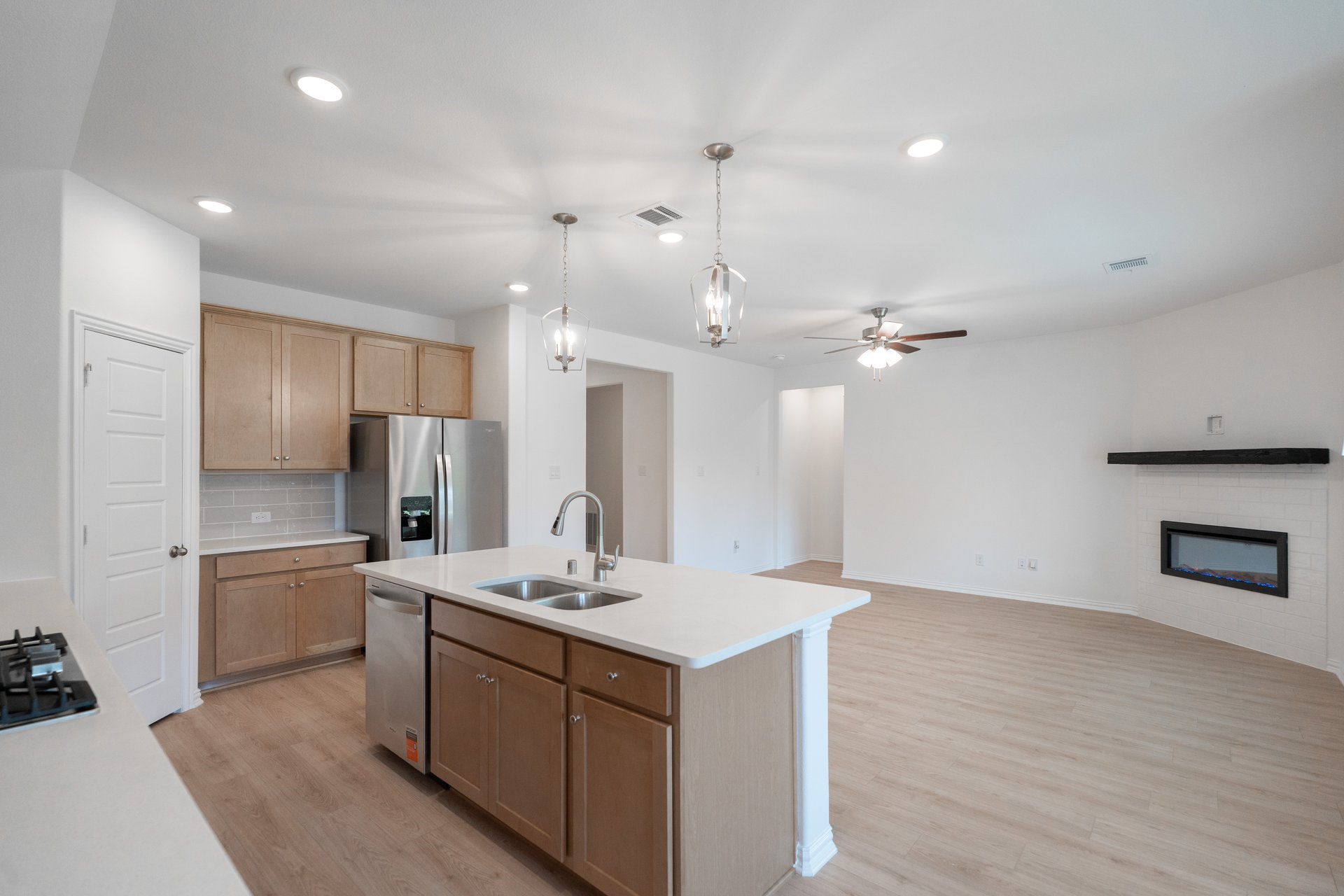 open kitchen with wood floors and island