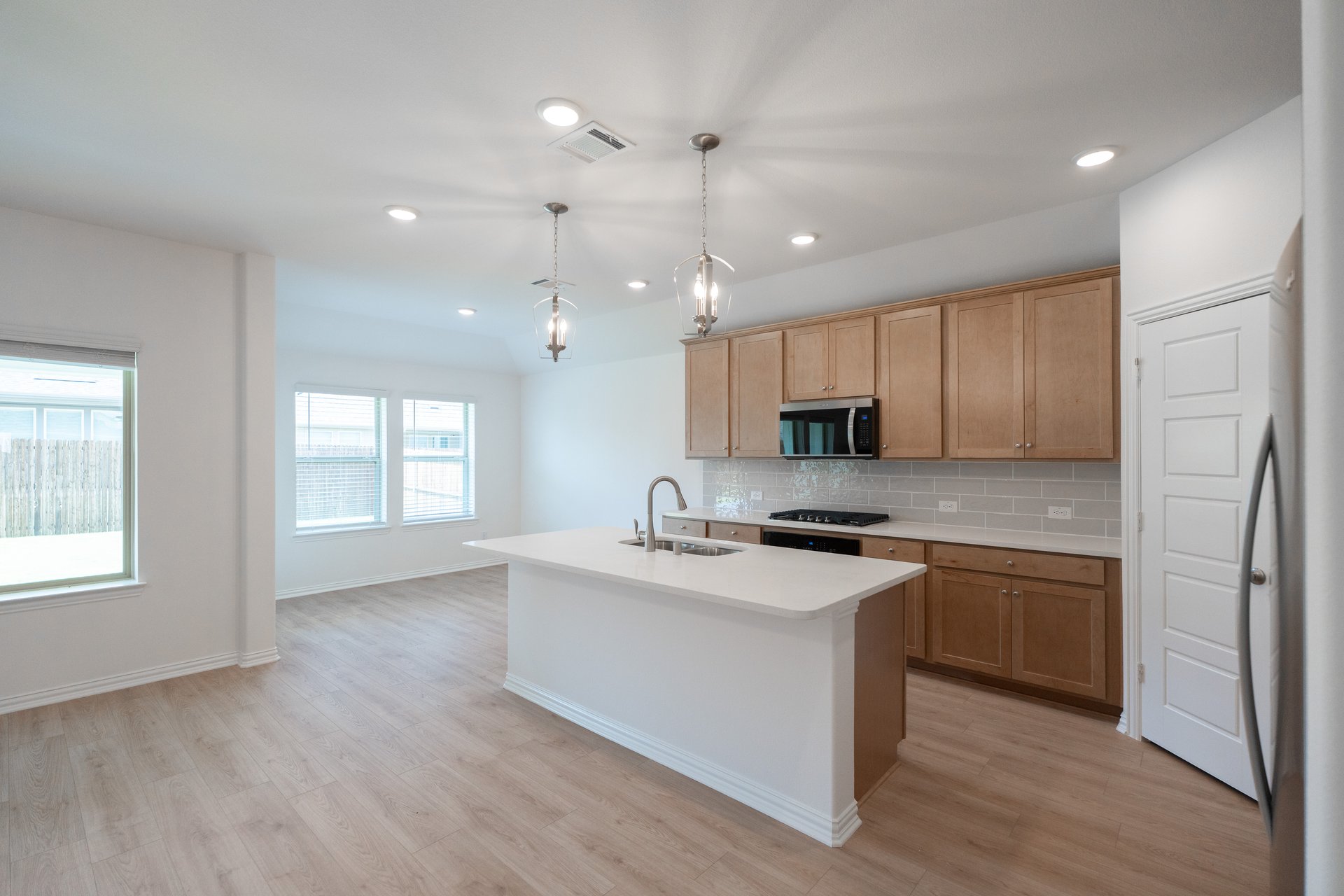 open kitchen with wood floors and island