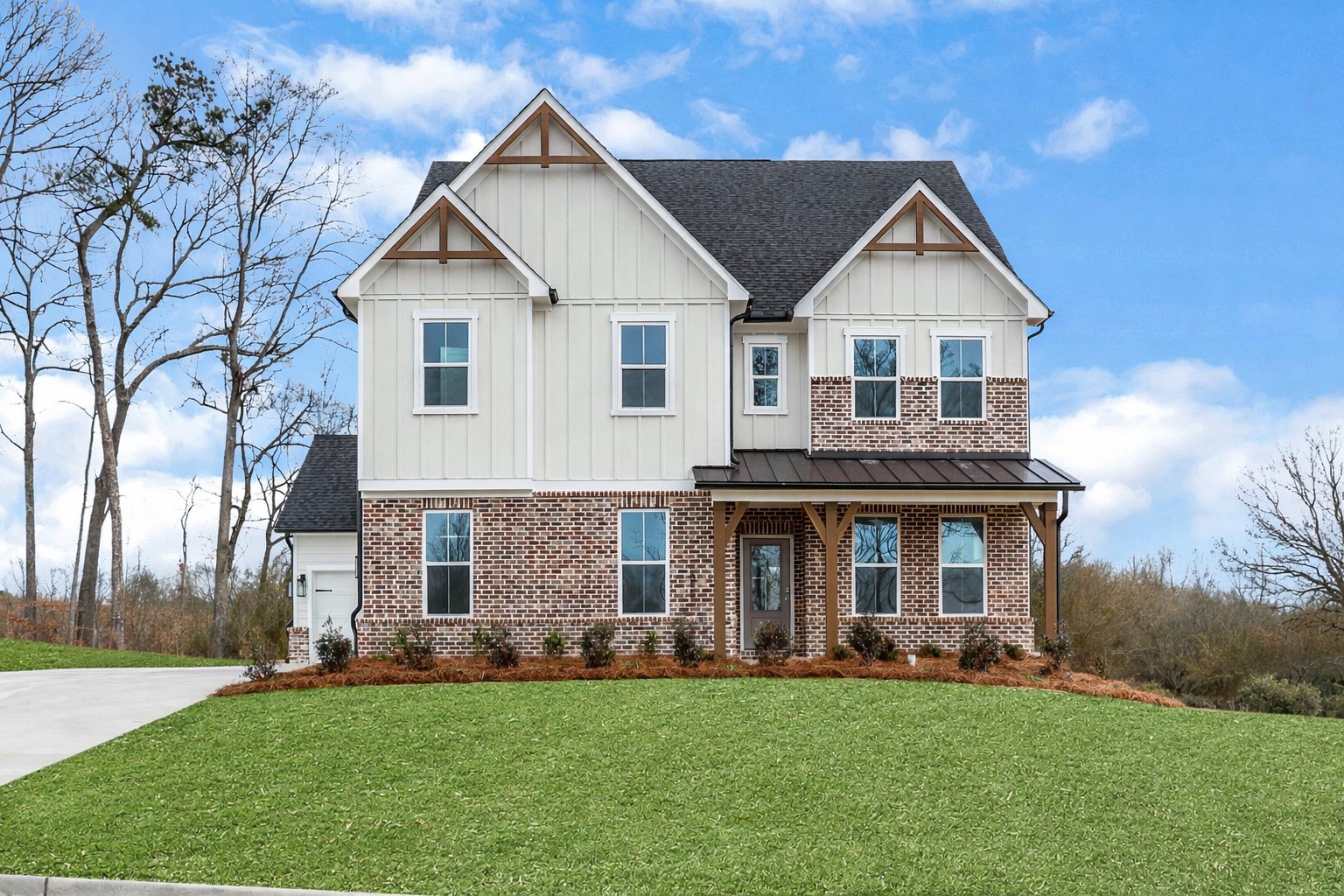 front of 2-story home with light siding and brick