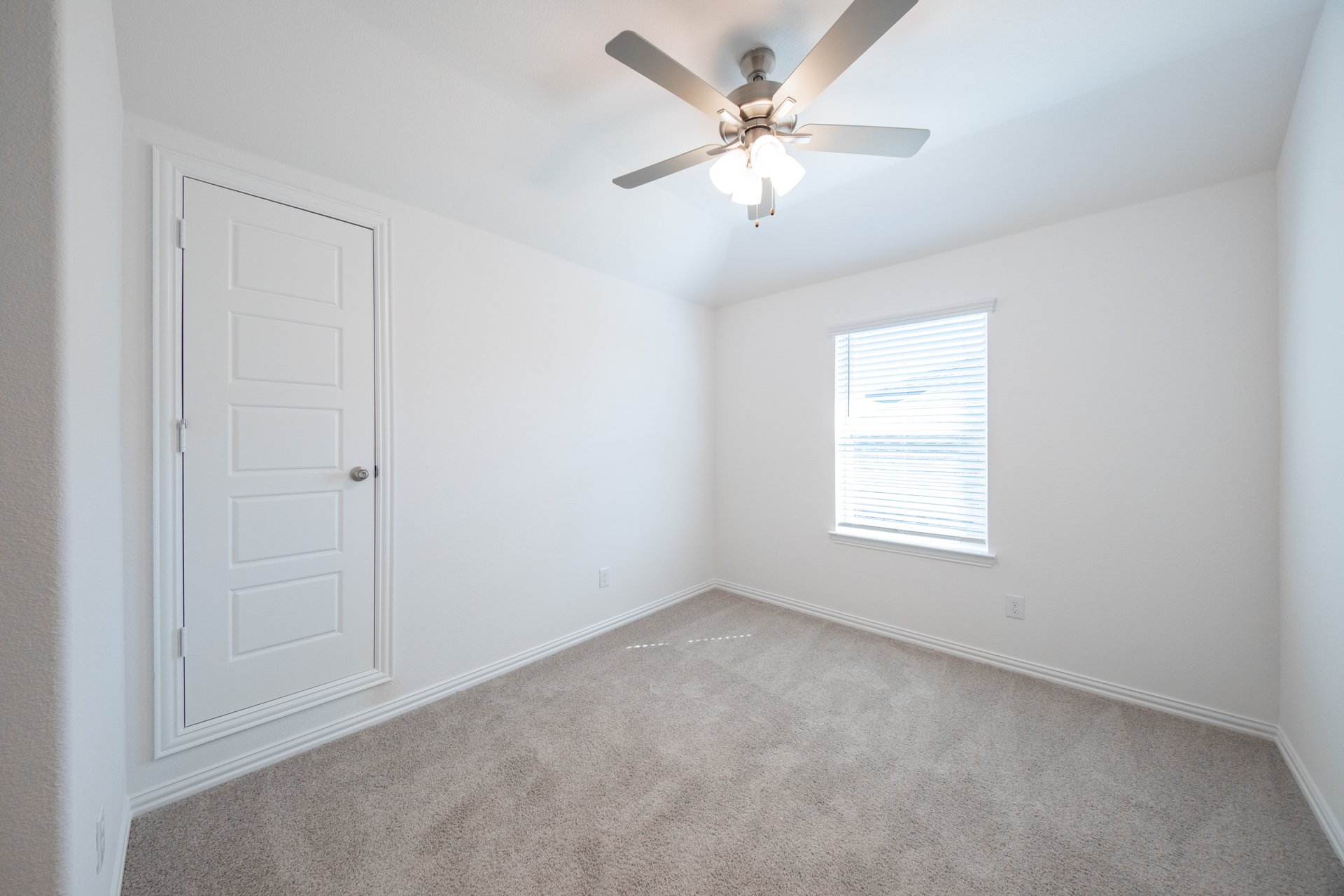 open loft with carpet and ceiling fan