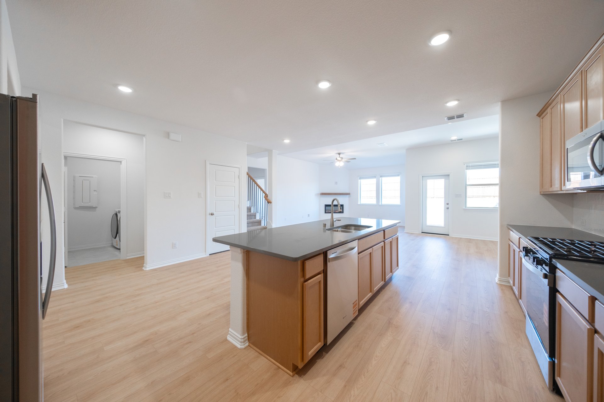 open kitchen with wood floors and island