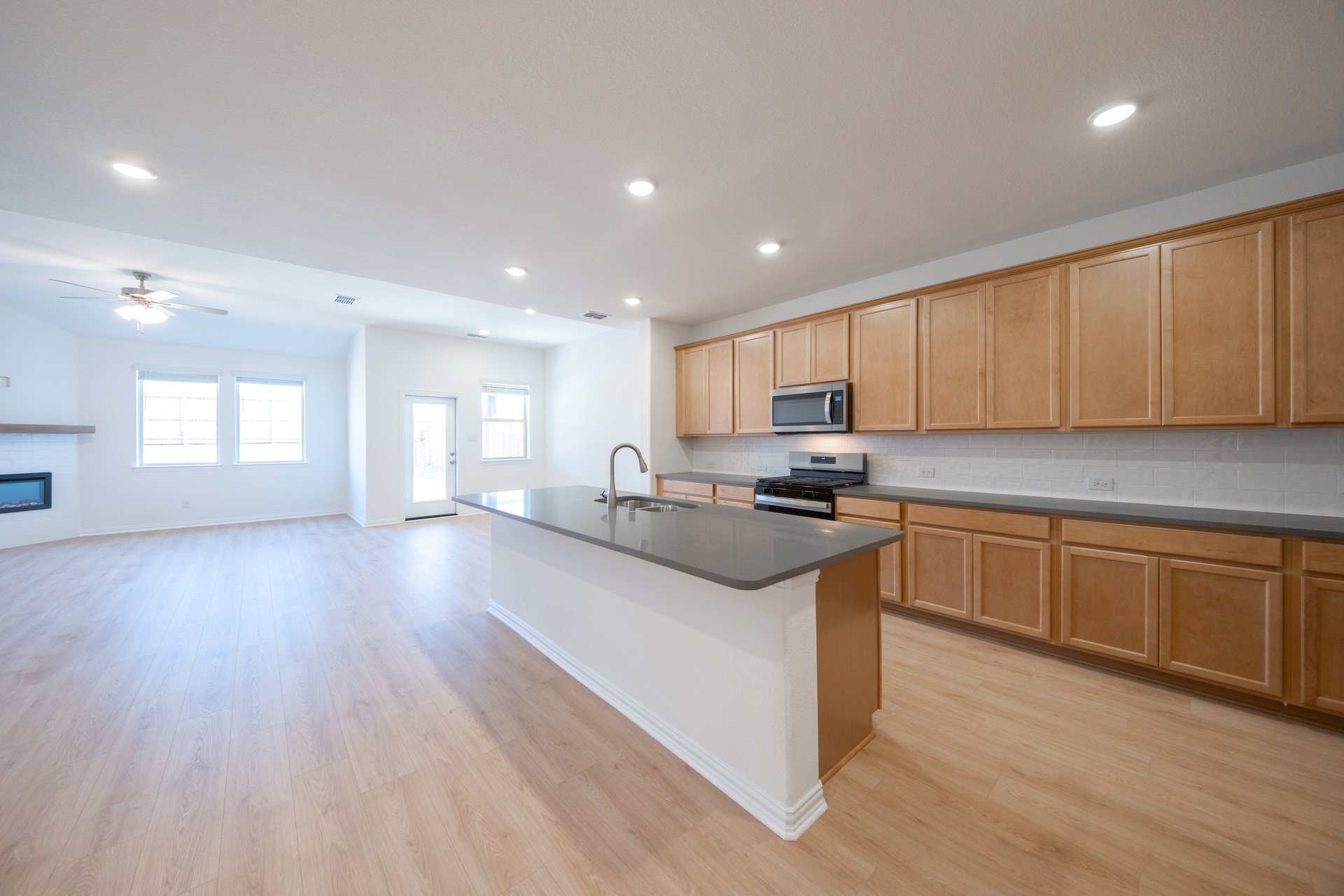 open kitchen with wood floors and island