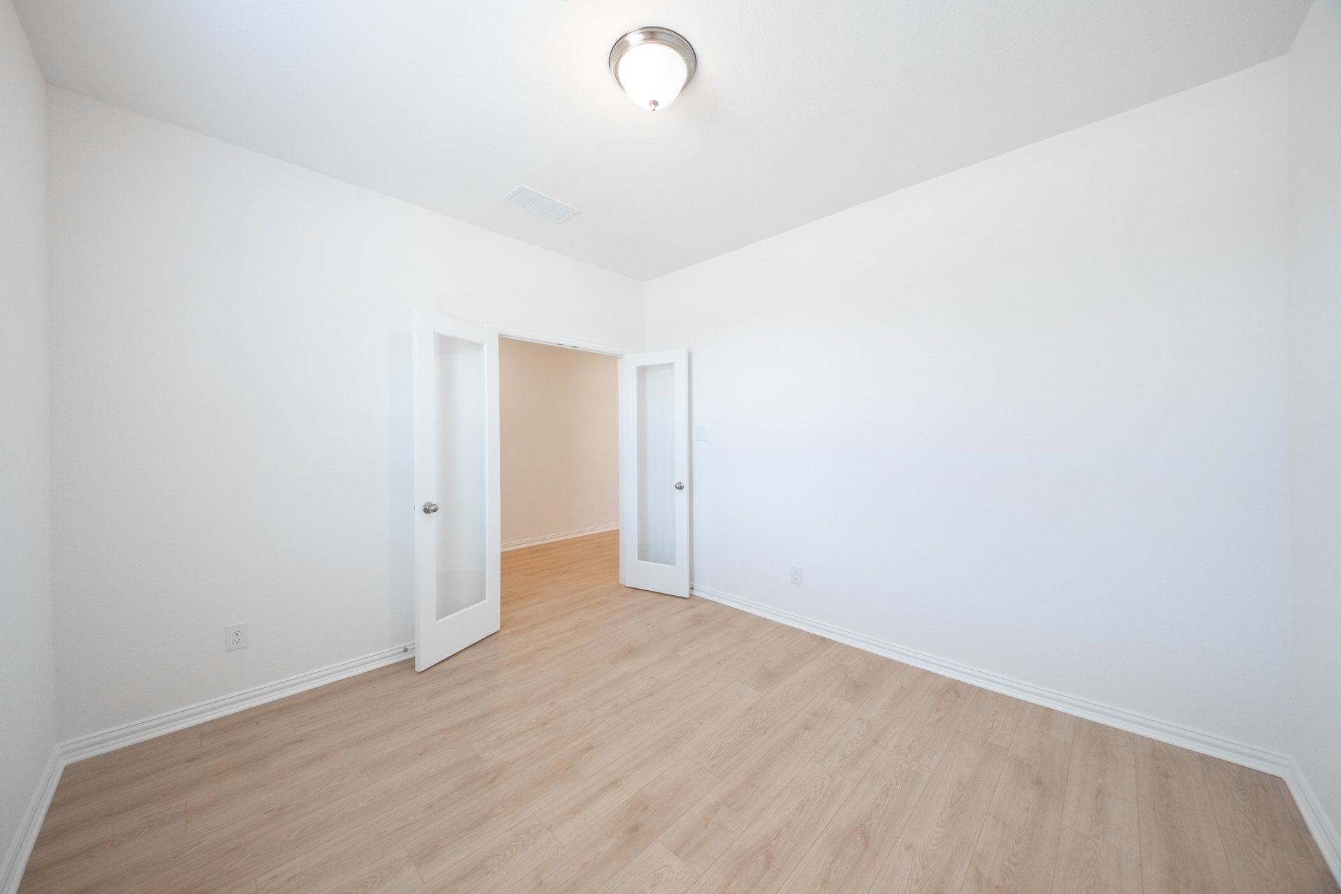 private study with wood floors and french doors