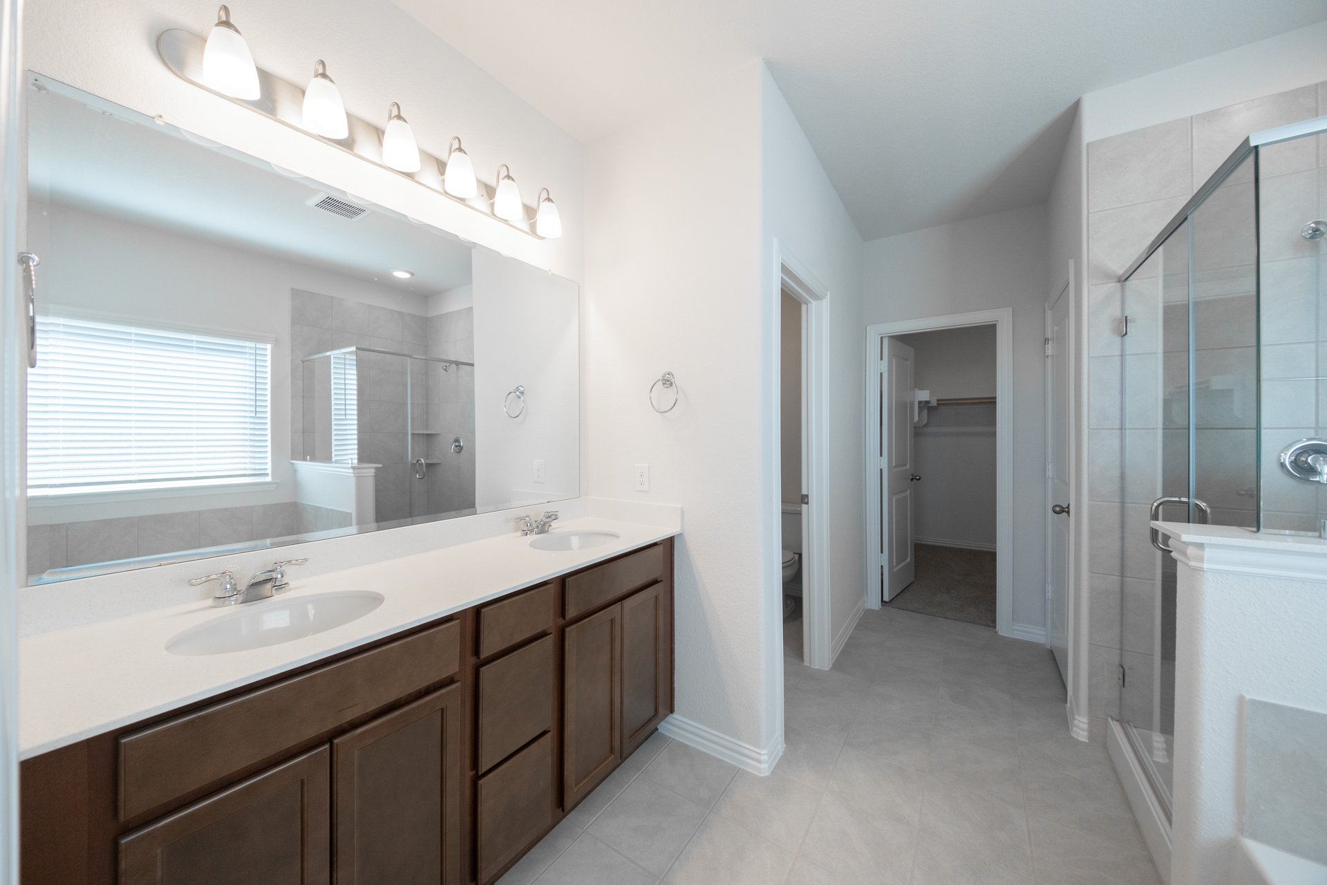 bathroom with dark cabinets and white countertops 