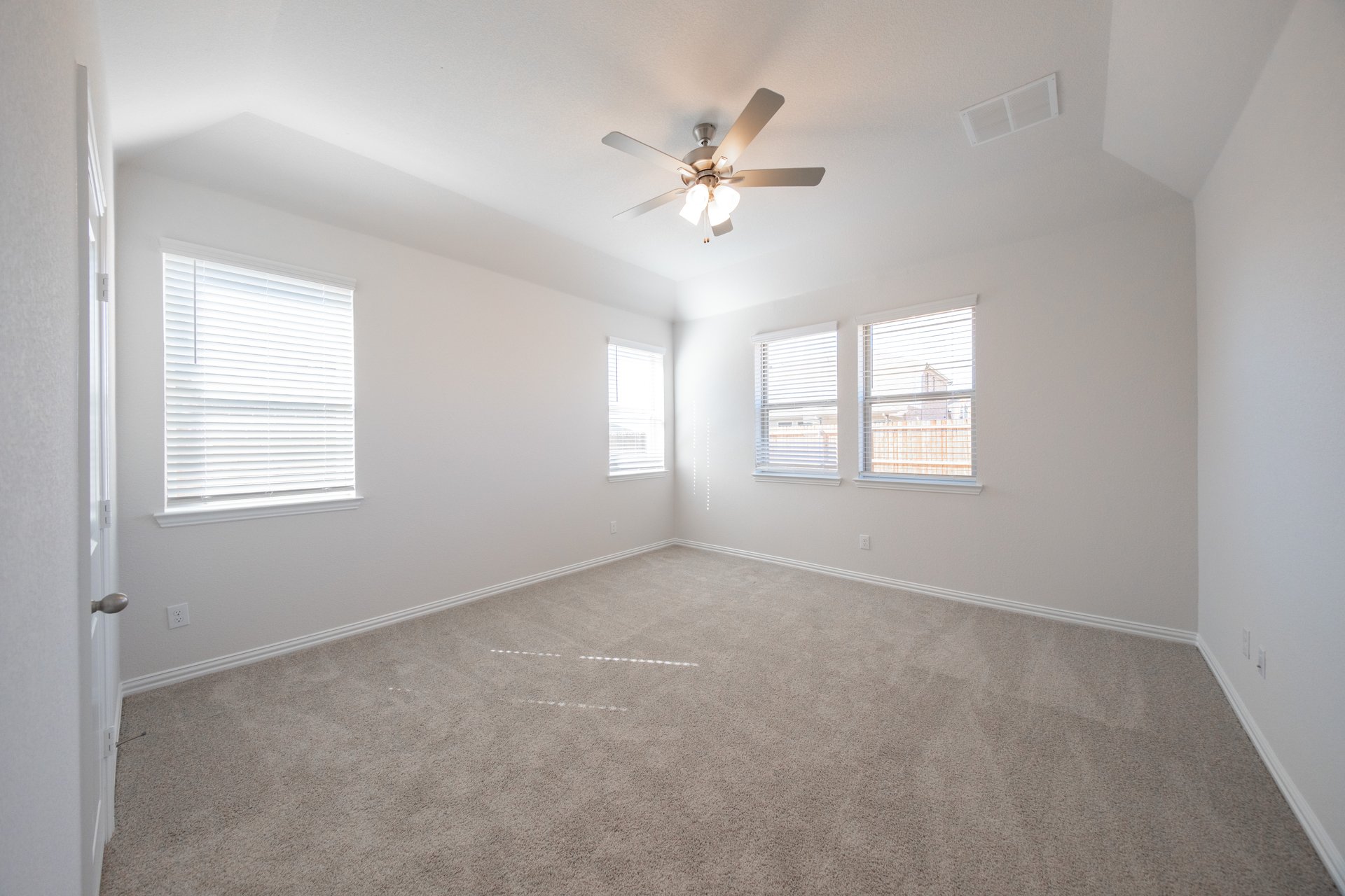 bedroom with carpet and windows with blinds 
