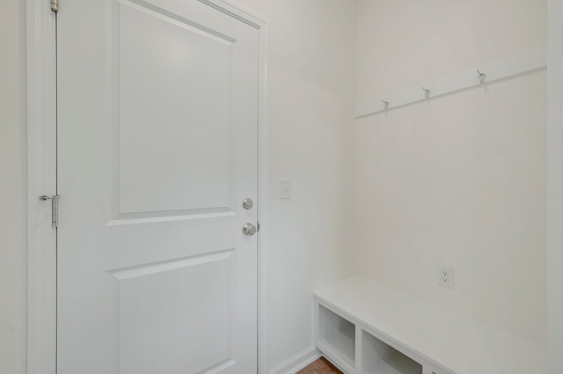 mudroom with a bench with cubbies and hooks