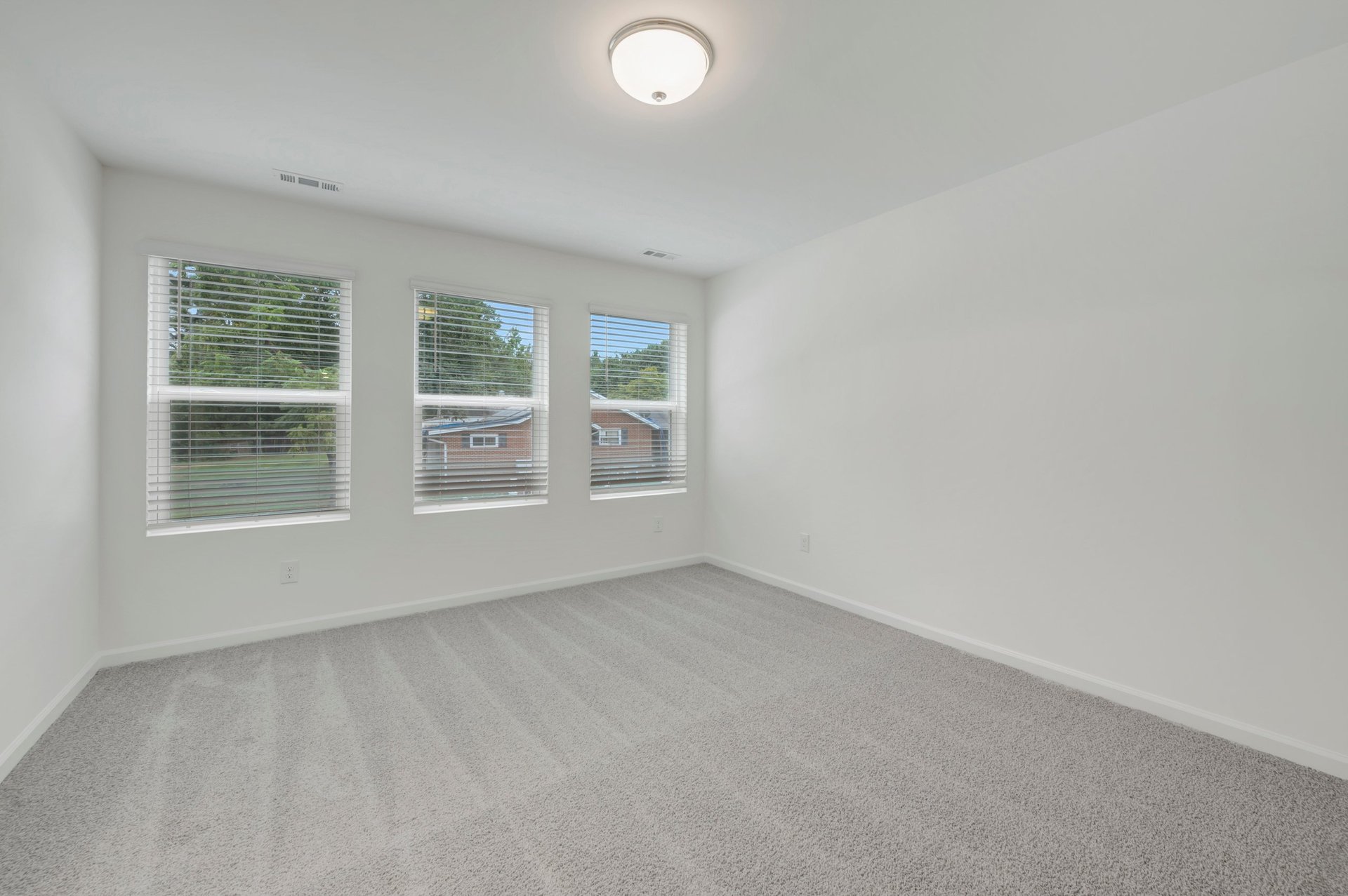 primary bedroom with three windows