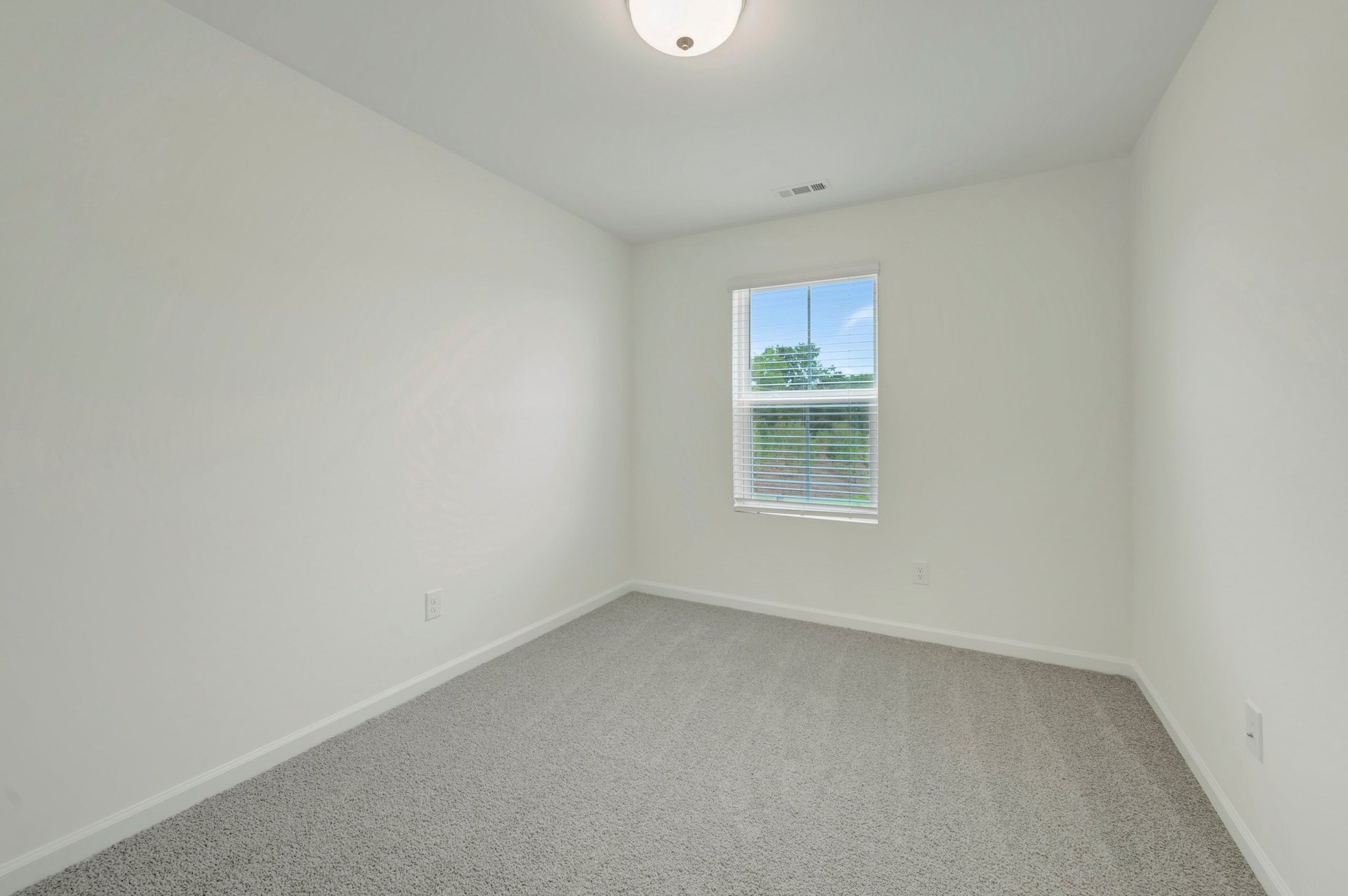 secondary bedroom with a window