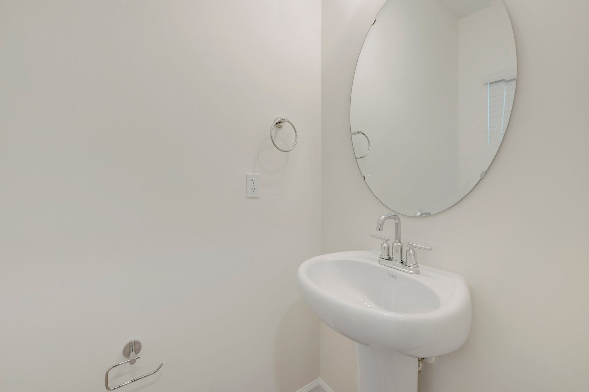 powder room with an oval mirror