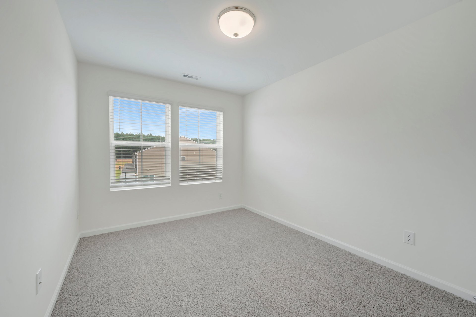 secondary bedroom with two windows