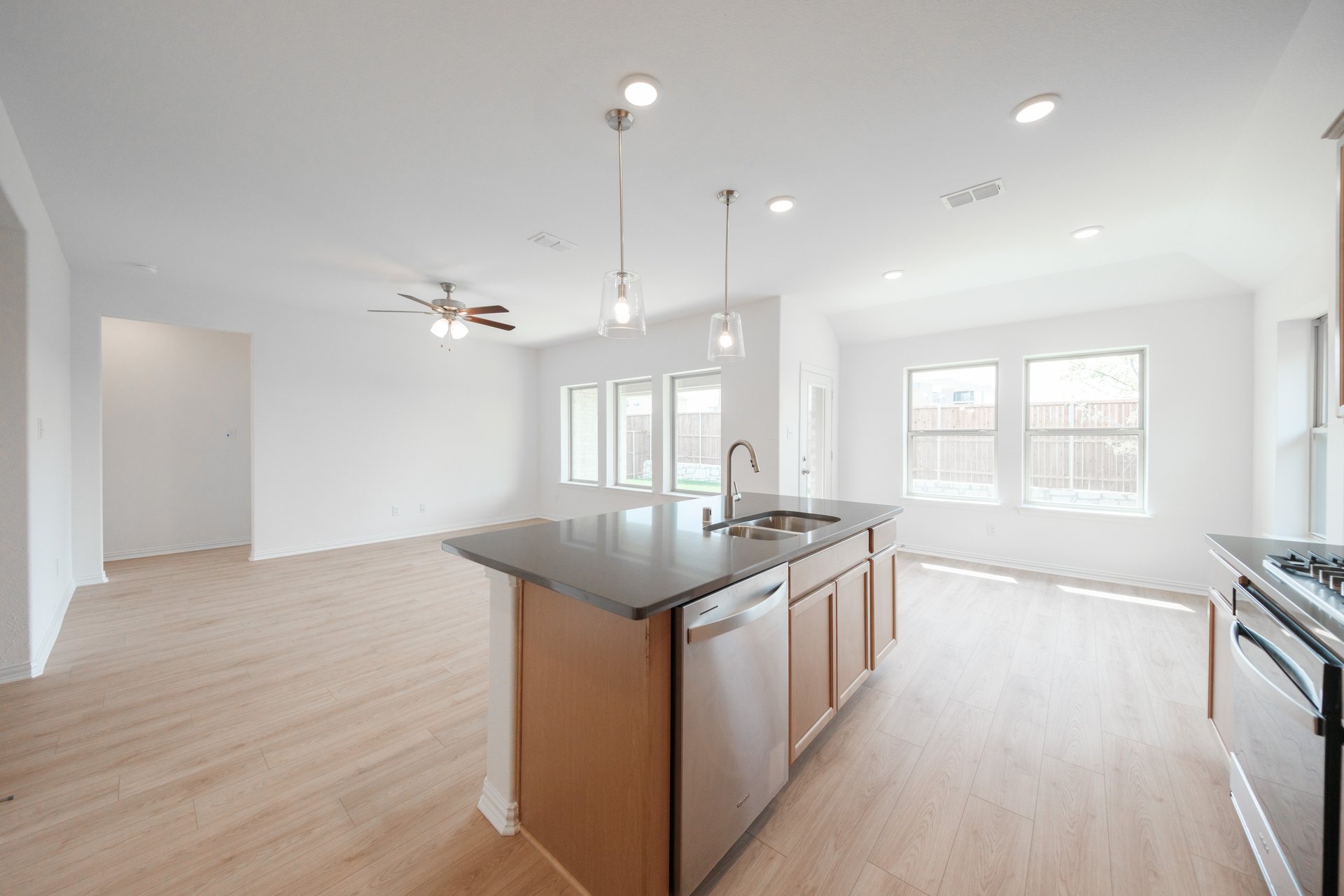 open kitchen with wood floors and island