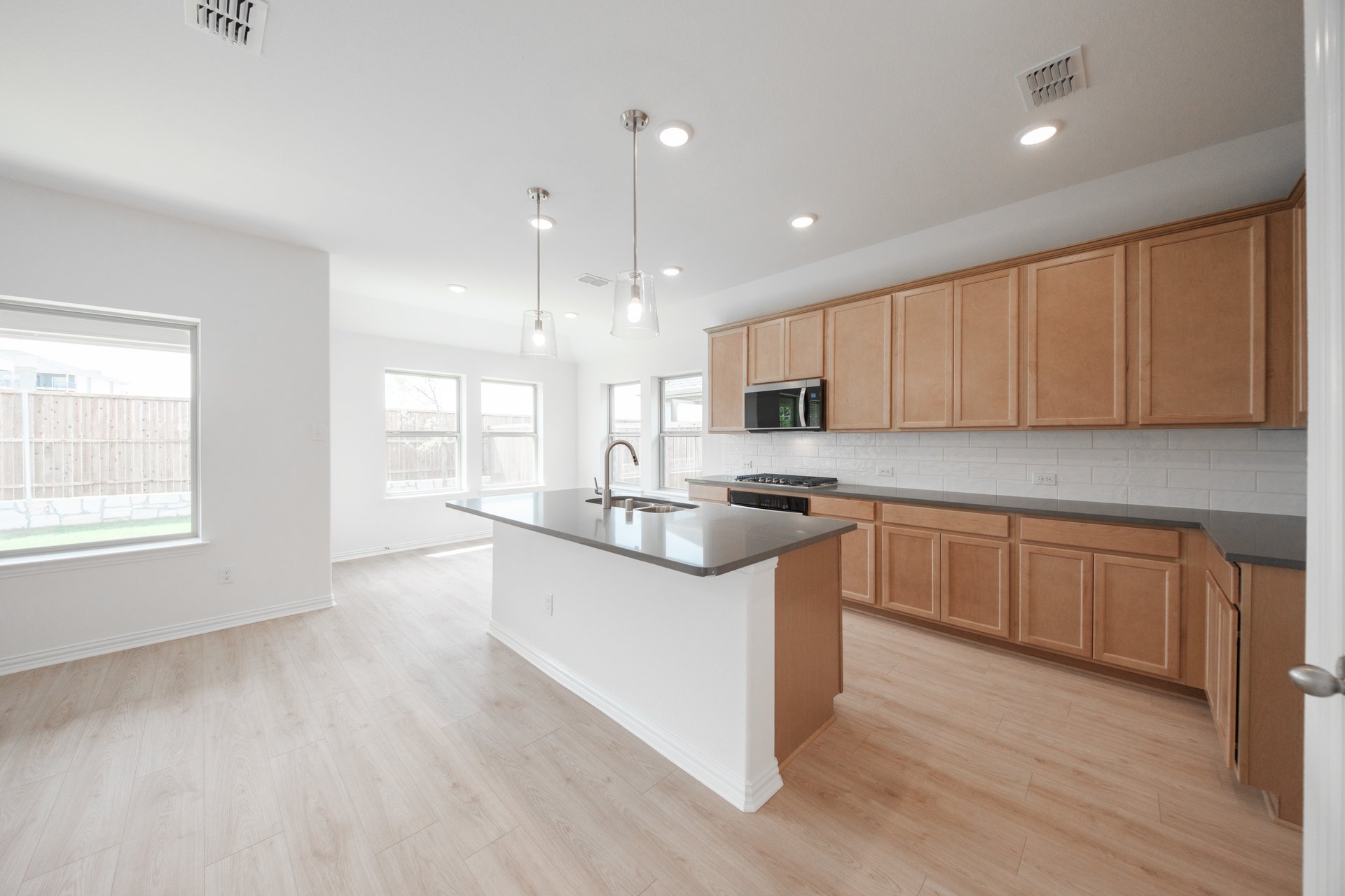 open kitchen with wood floors and island