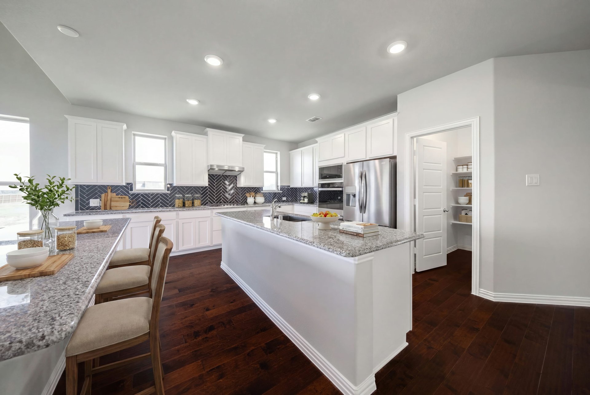 open kitchen with white cabinetry and hardwood flooring