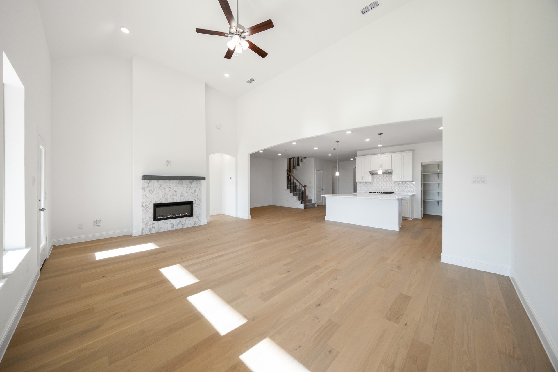 open great room with wood floors and fireplace