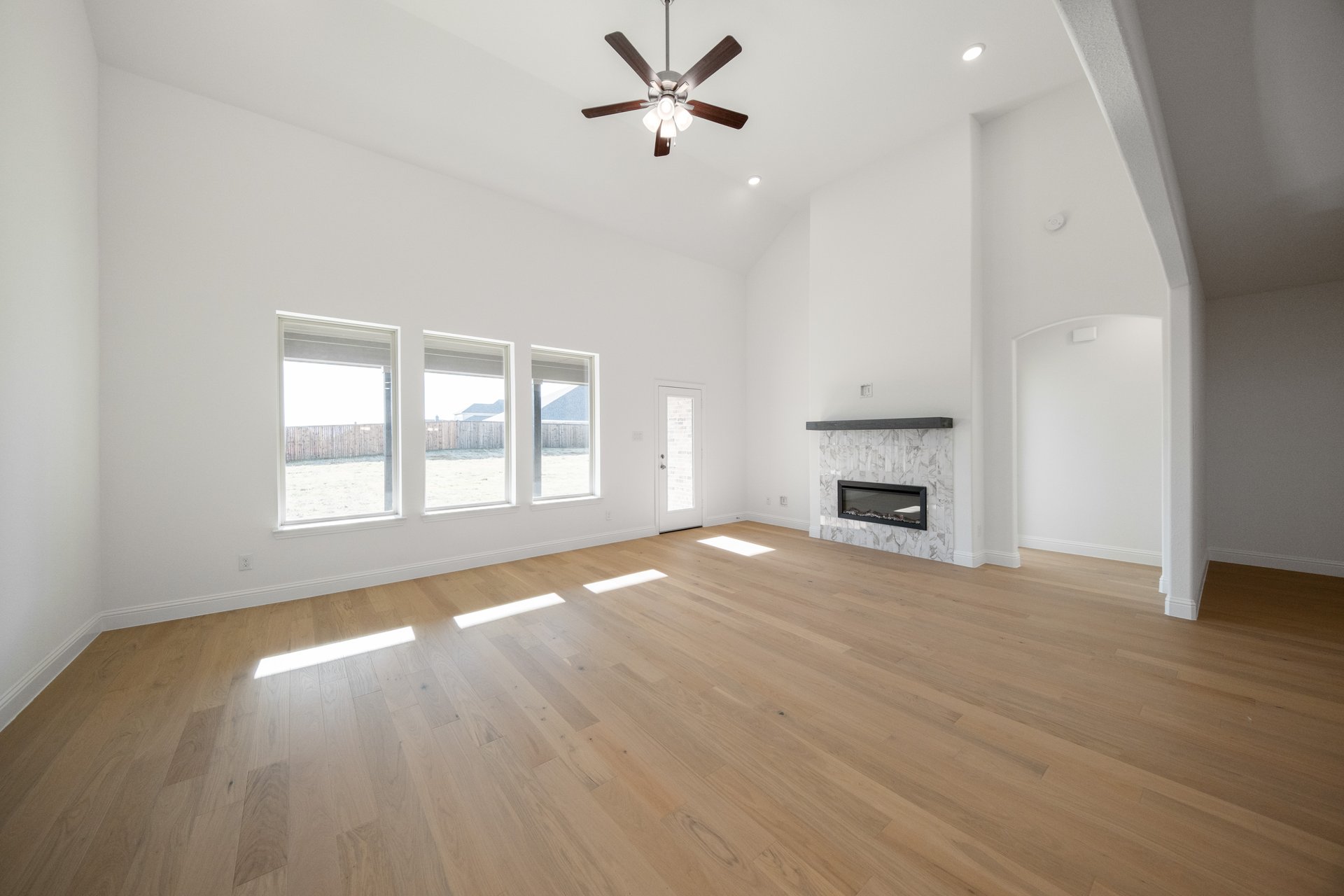 open great room with wood floors and fireplace