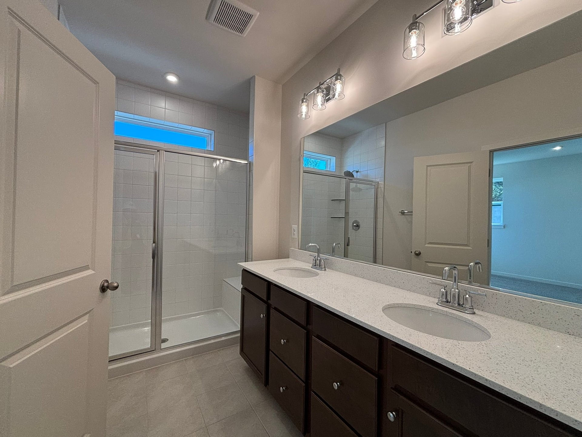 primary bathroom with a shower with a window
