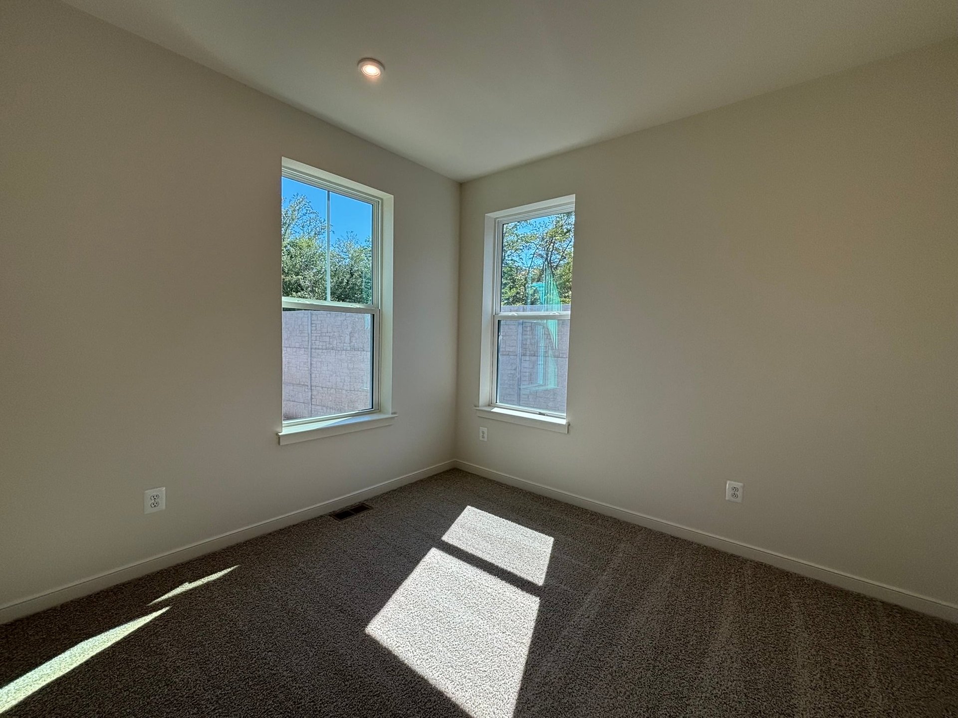 secondary bedroom with two windows