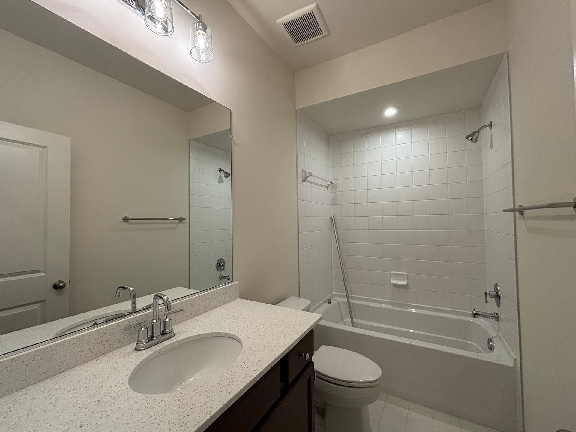 secondary bathroom with a shower and tub combo