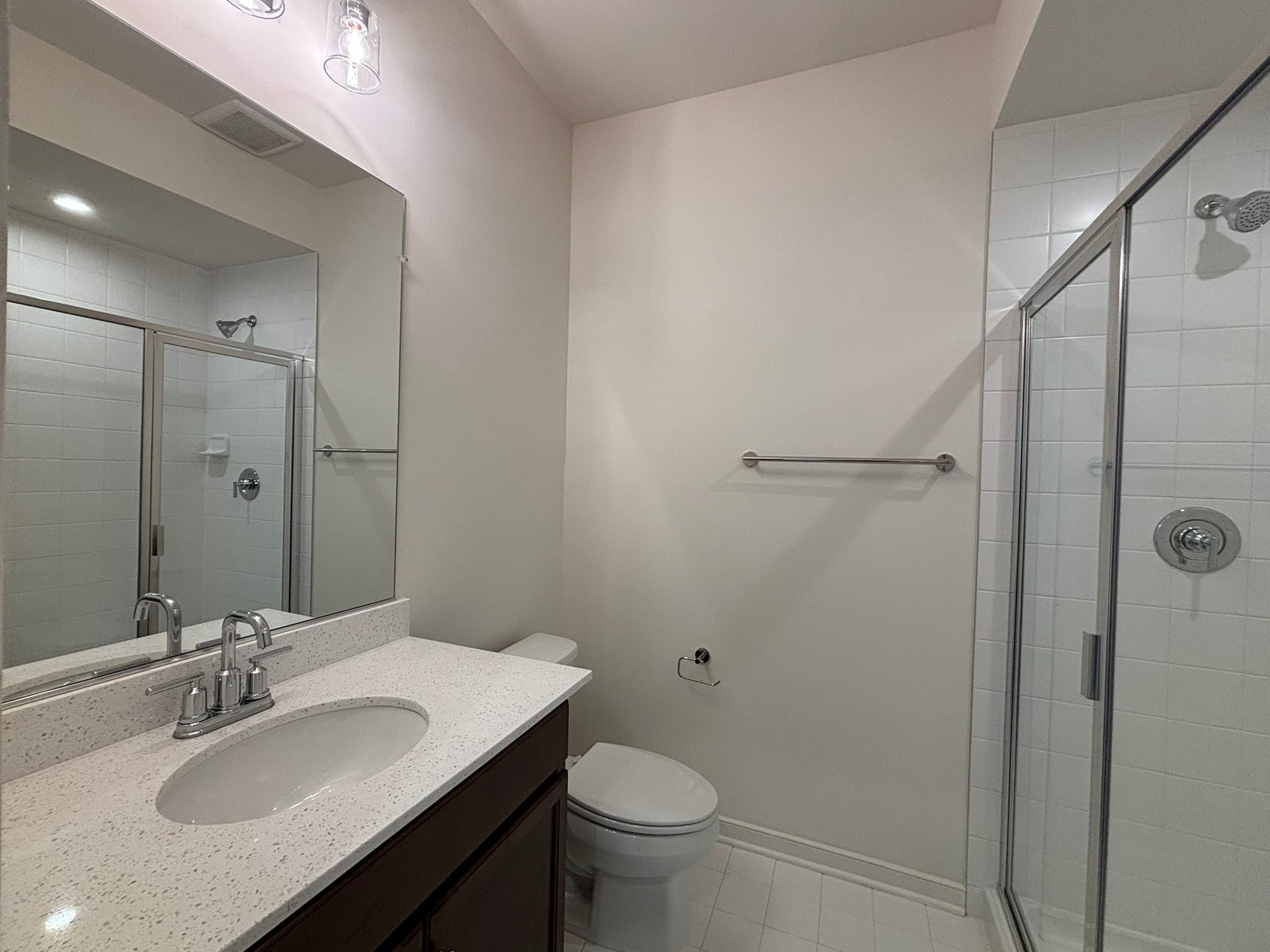 secondary bathroom with a walk-in shower