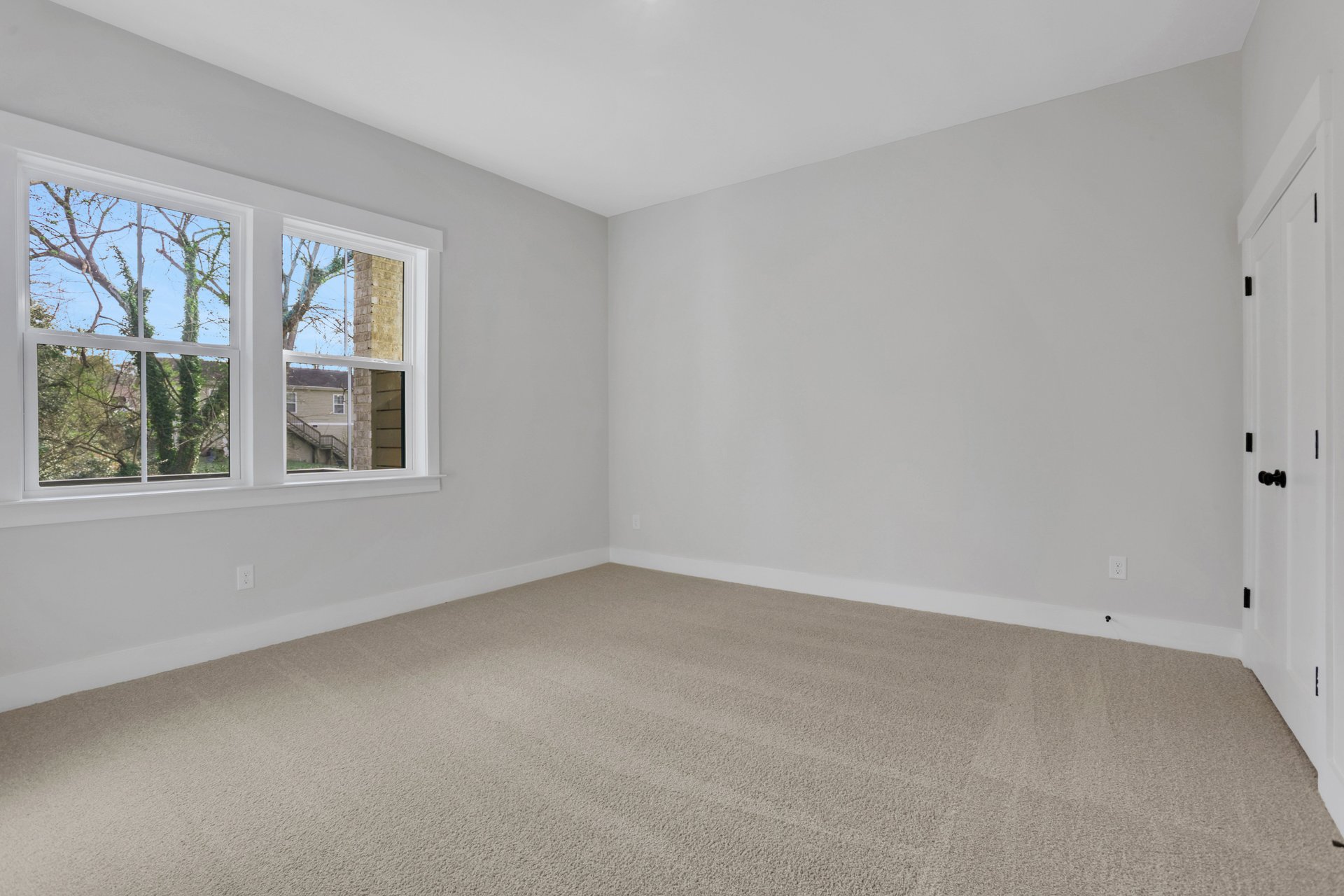 bedroom with carpet and windows