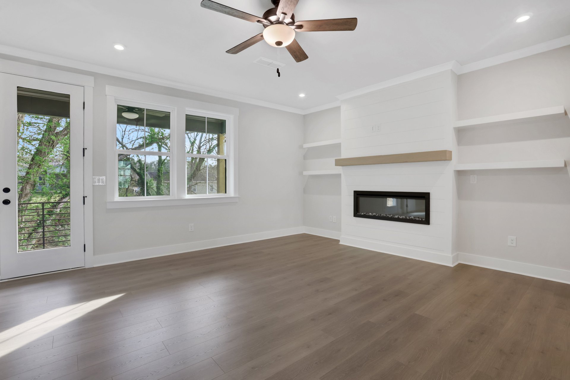 great room with built-in shelves and fireplace
