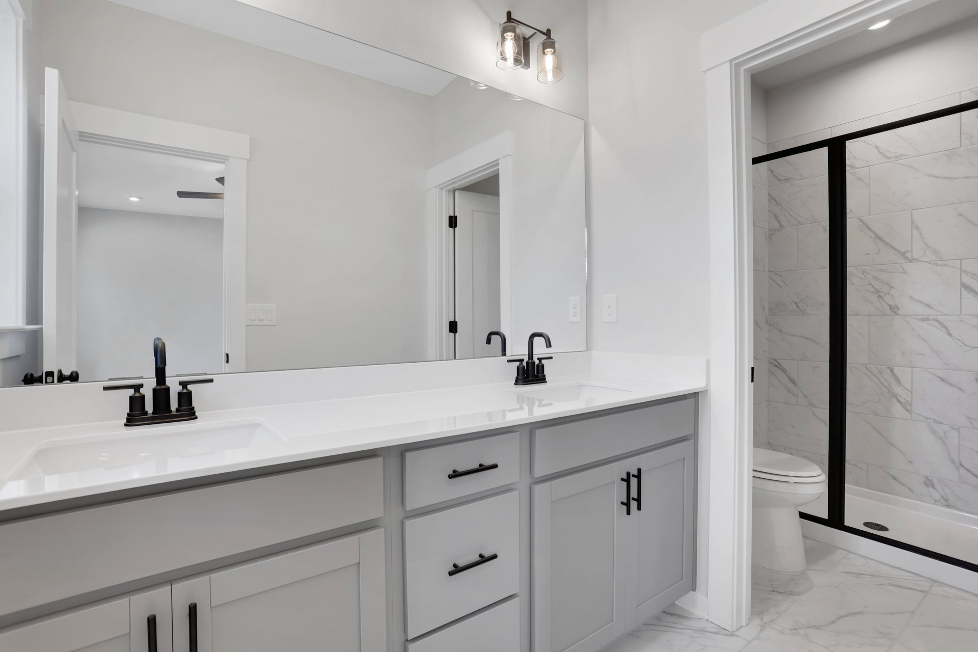 bathroom with gray cabinets and white quartz counters