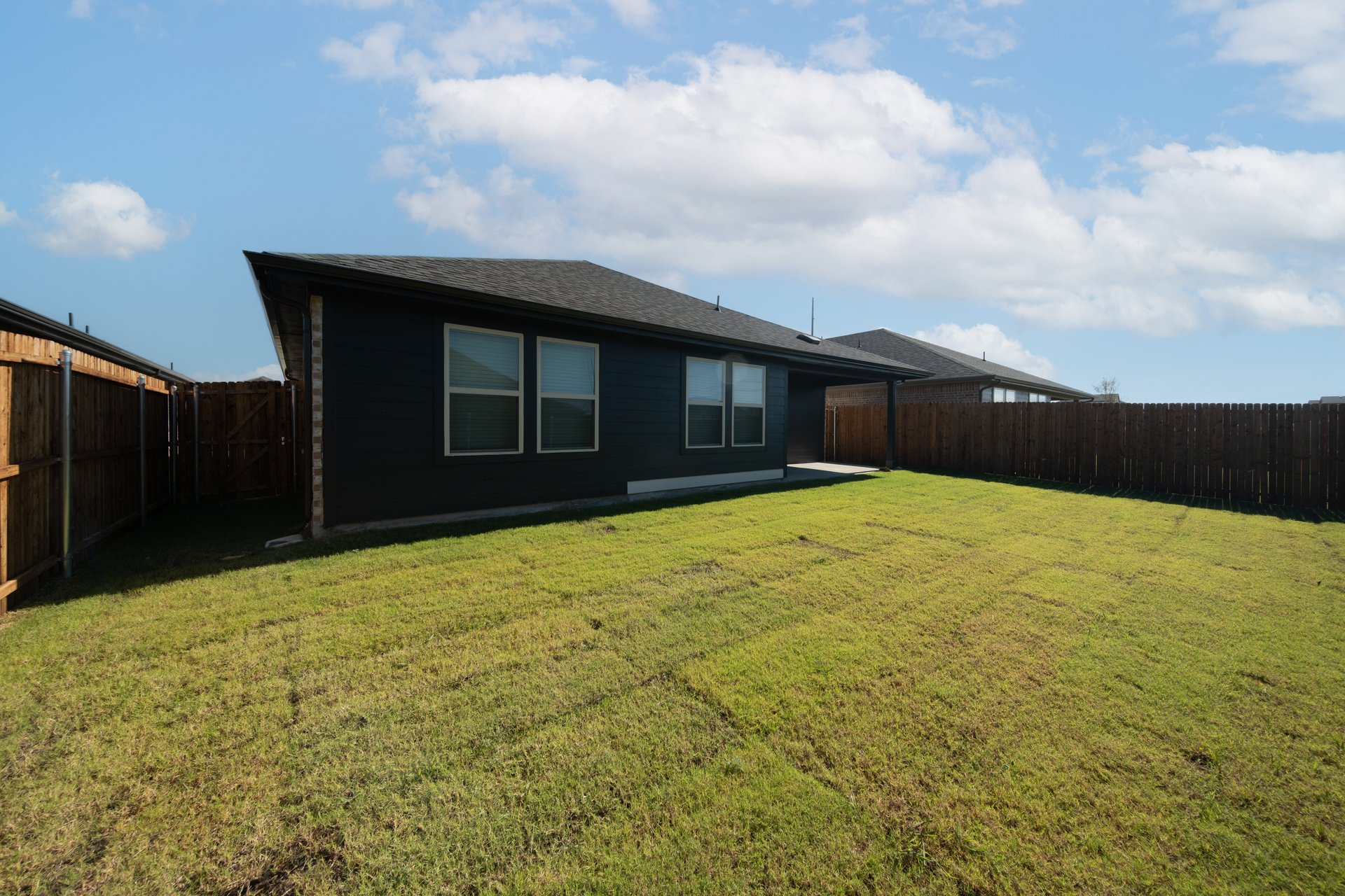 backyard with grass and covered patio